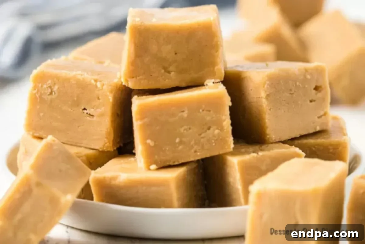 Peanut butter fudge cut into perfect squares, showcasing its creamy texture.
