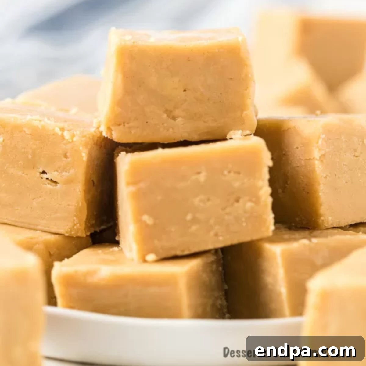 Peanut butter fudge cut into squares, showcasing its perfect texture.
