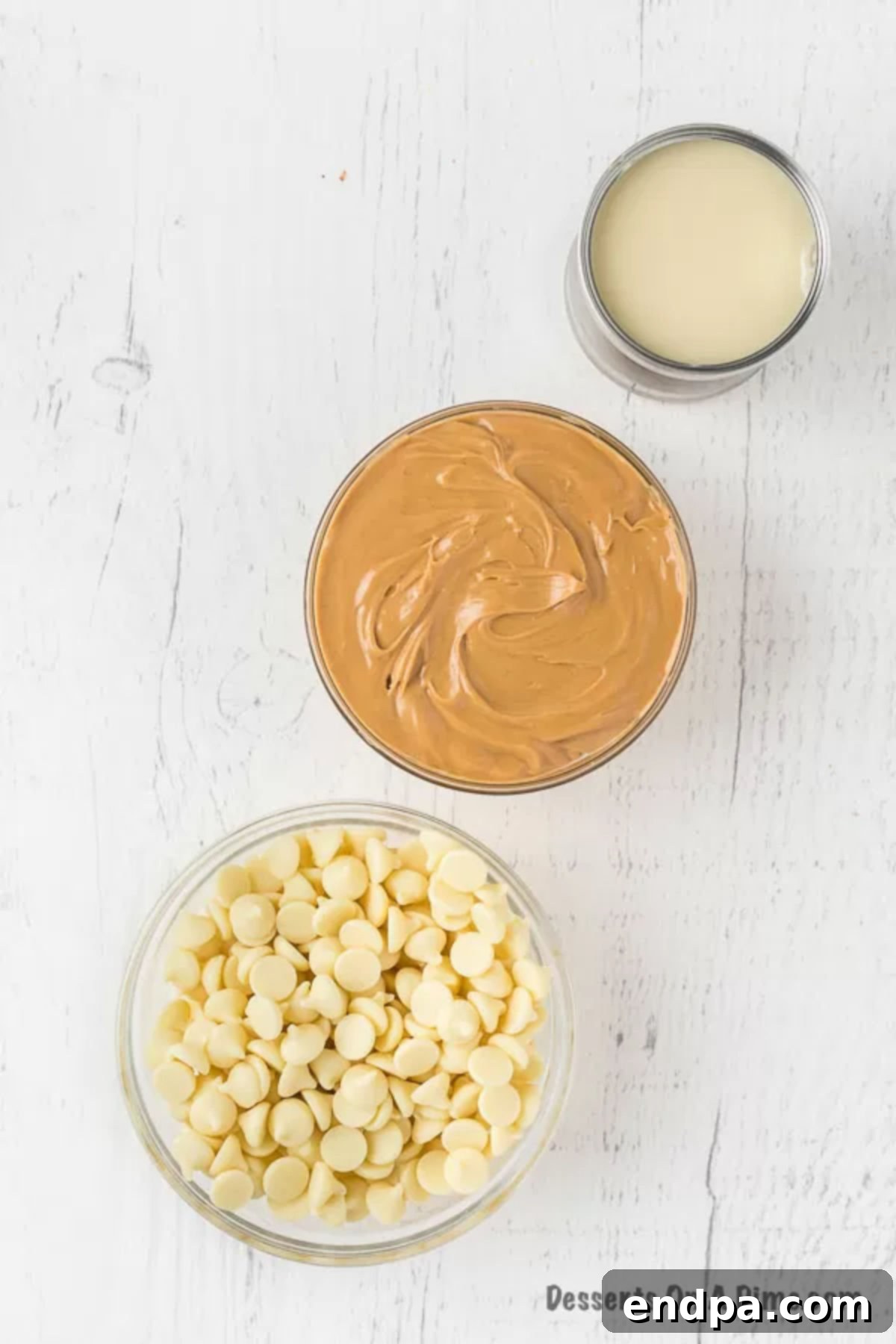 Ingredients for Peanut Butter Fudge: white chocolate chips, creamy peanut butter, and a can of sweetened condensed milk.