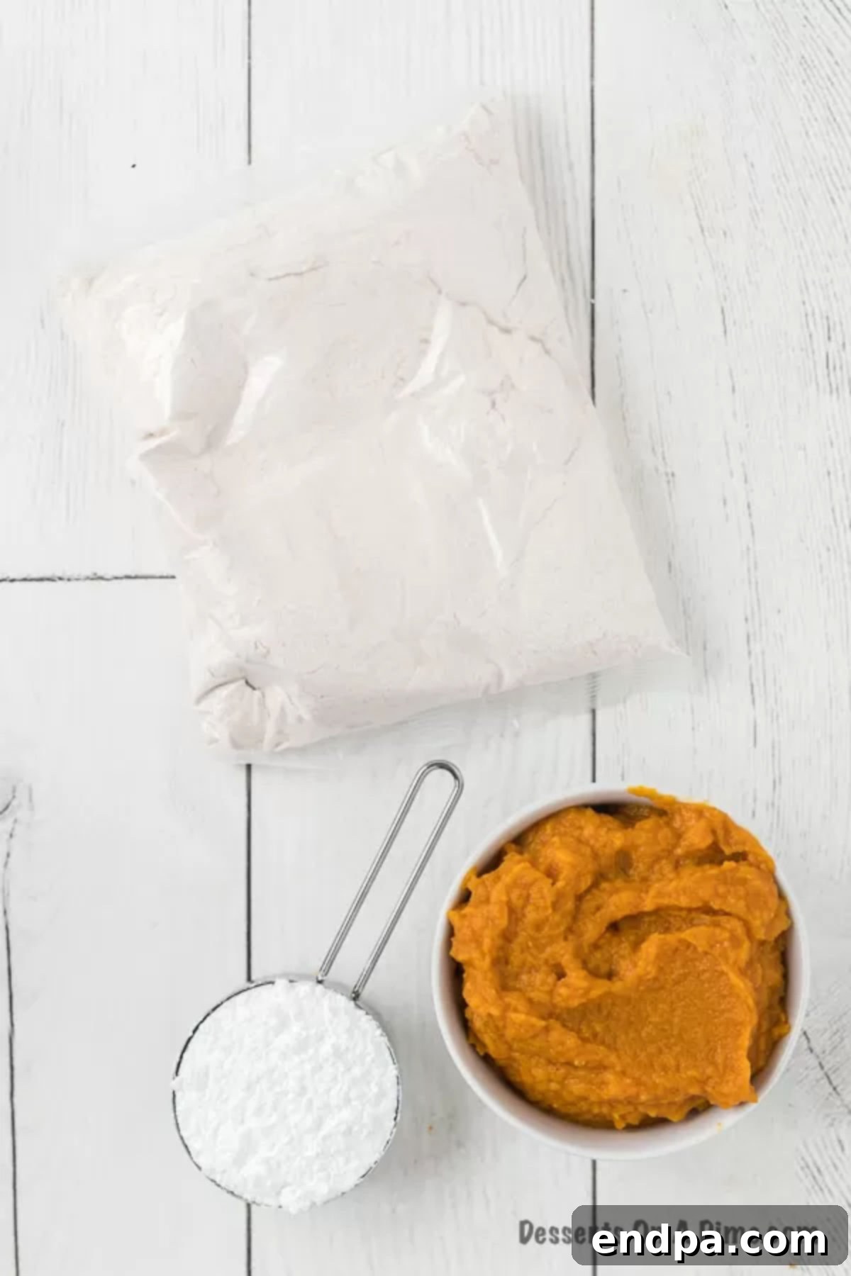 Ingredients to make these pumpkin cake mix cookies - pumpkin puree, spice cake mix, powdered sugar. 