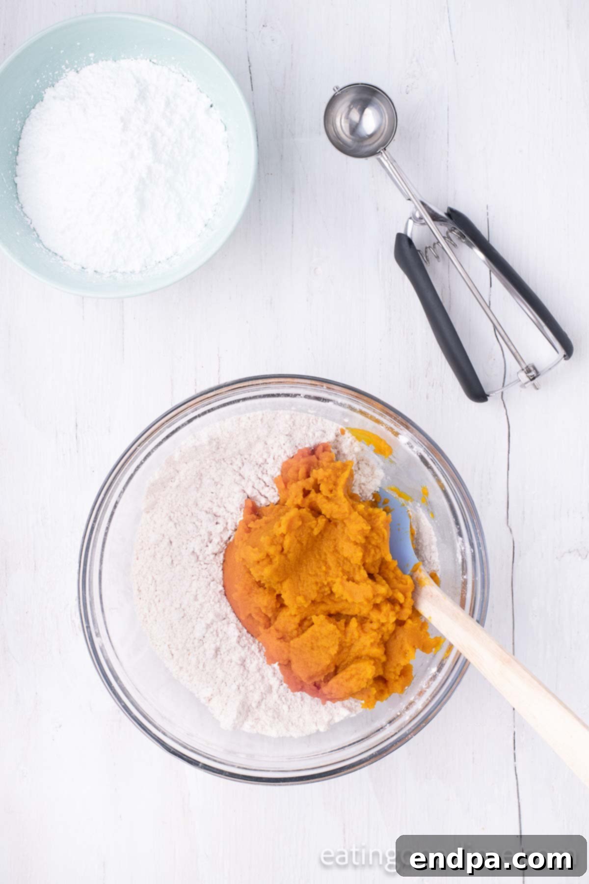 Mixing bowl with cake mix and pumpkin. 