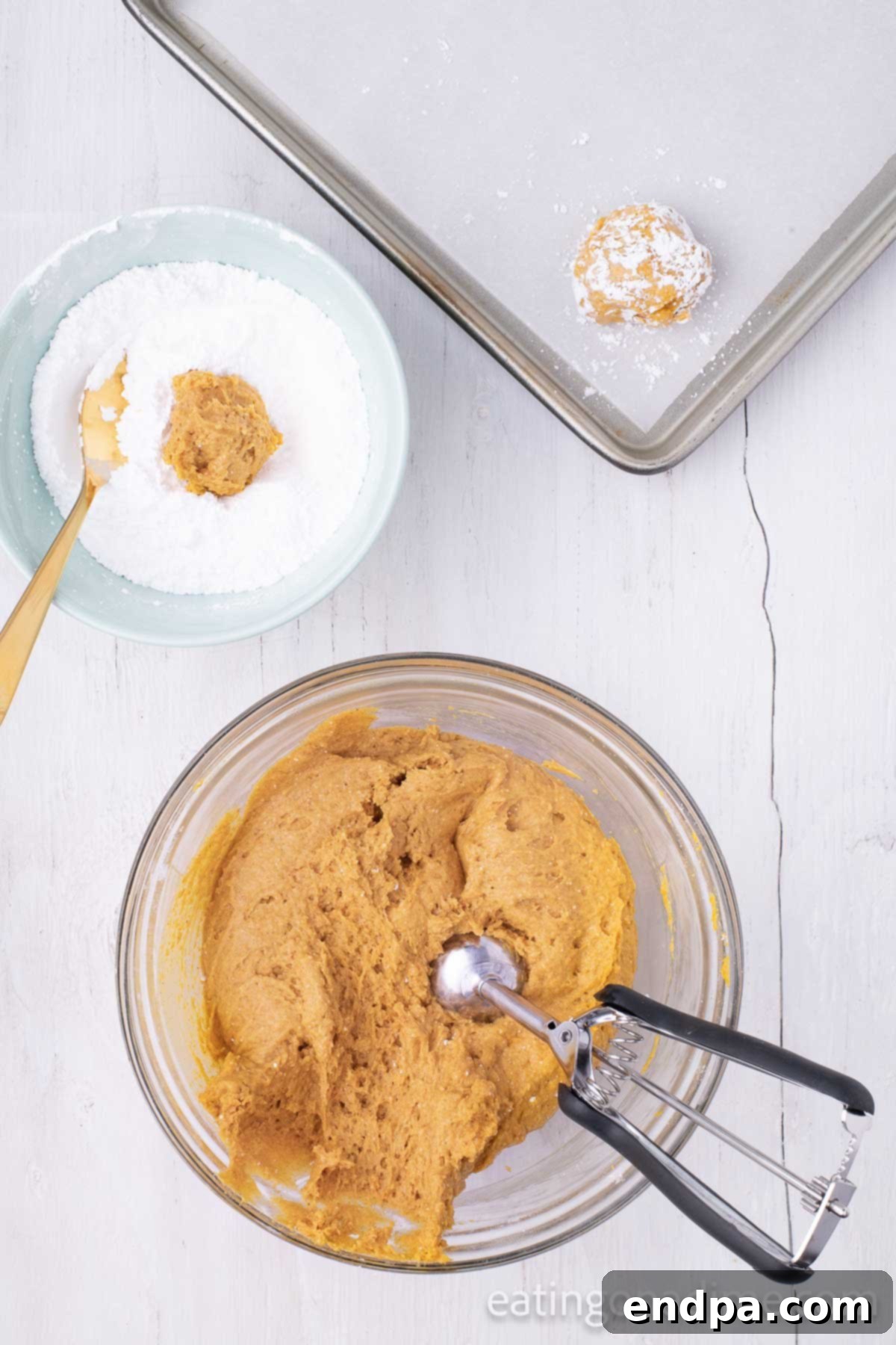 Mixing bowl with cookies being scooped. 