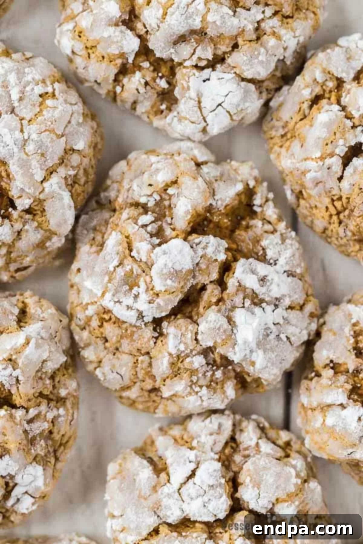 Pumpkin Cake Mix Cookies laying next to each other on a wooden board. 