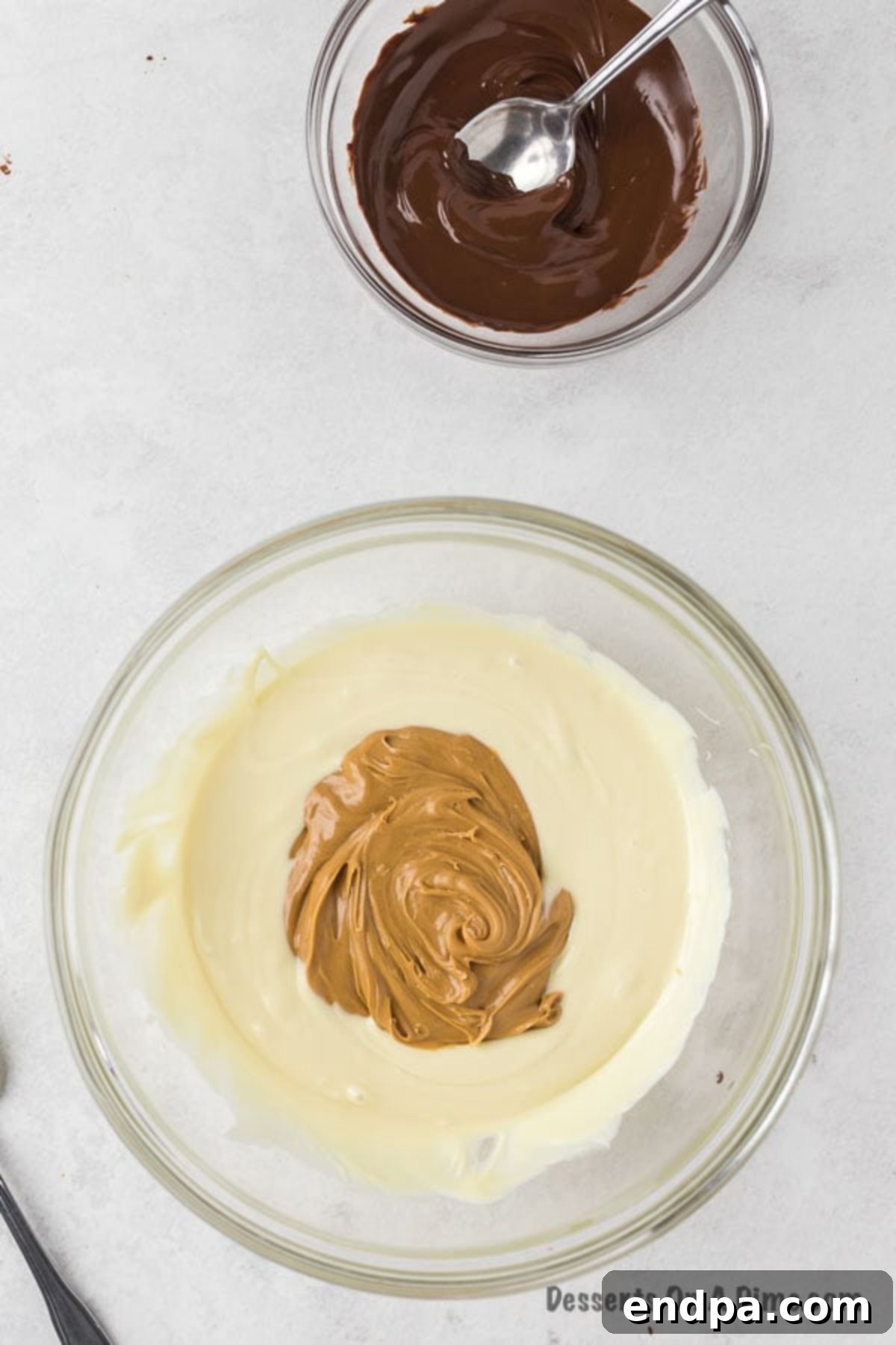 Mixing creamy peanut butter into the melted vanilla chips until smooth