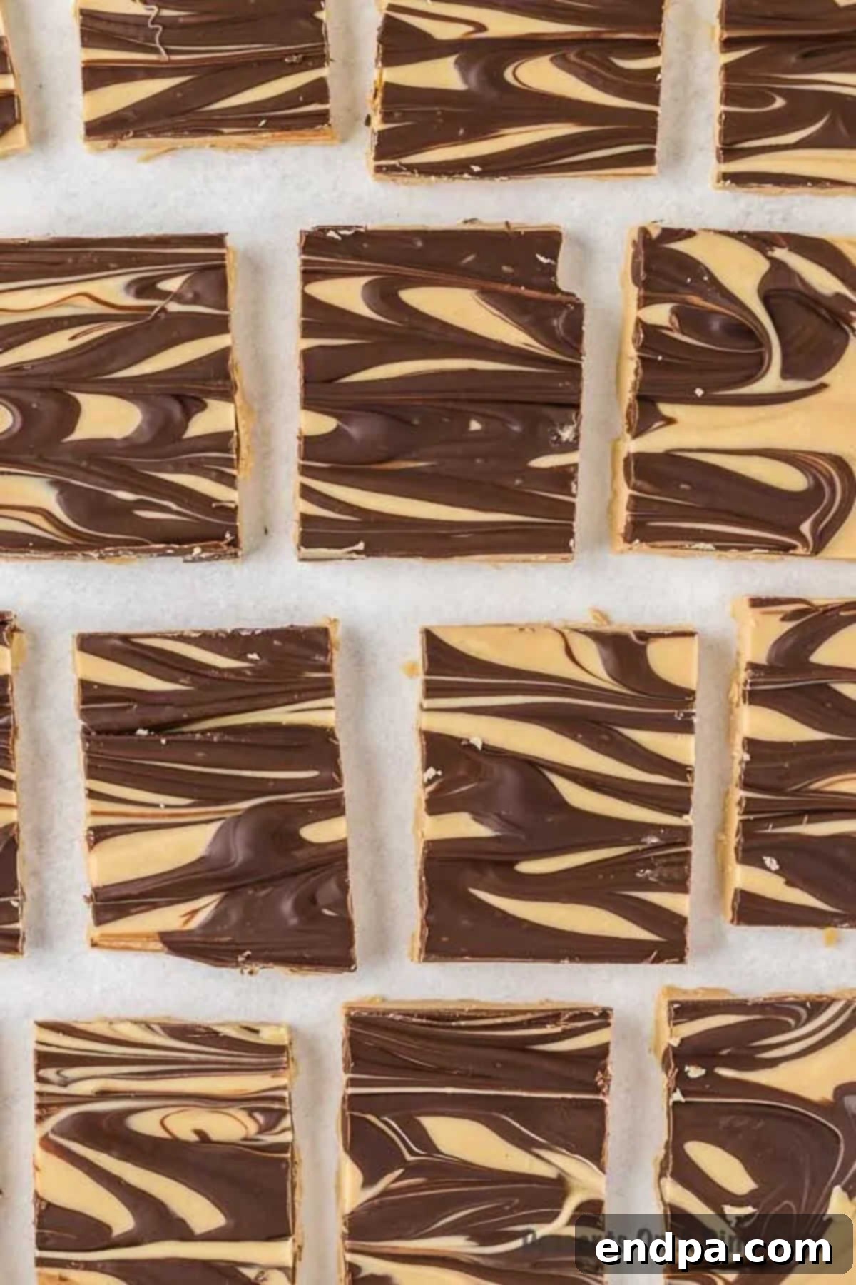 Close-up of Tiger Butter Fudge cut into perfect squares, highlighting the intricate swirl pattern of chocolate and peanut butter