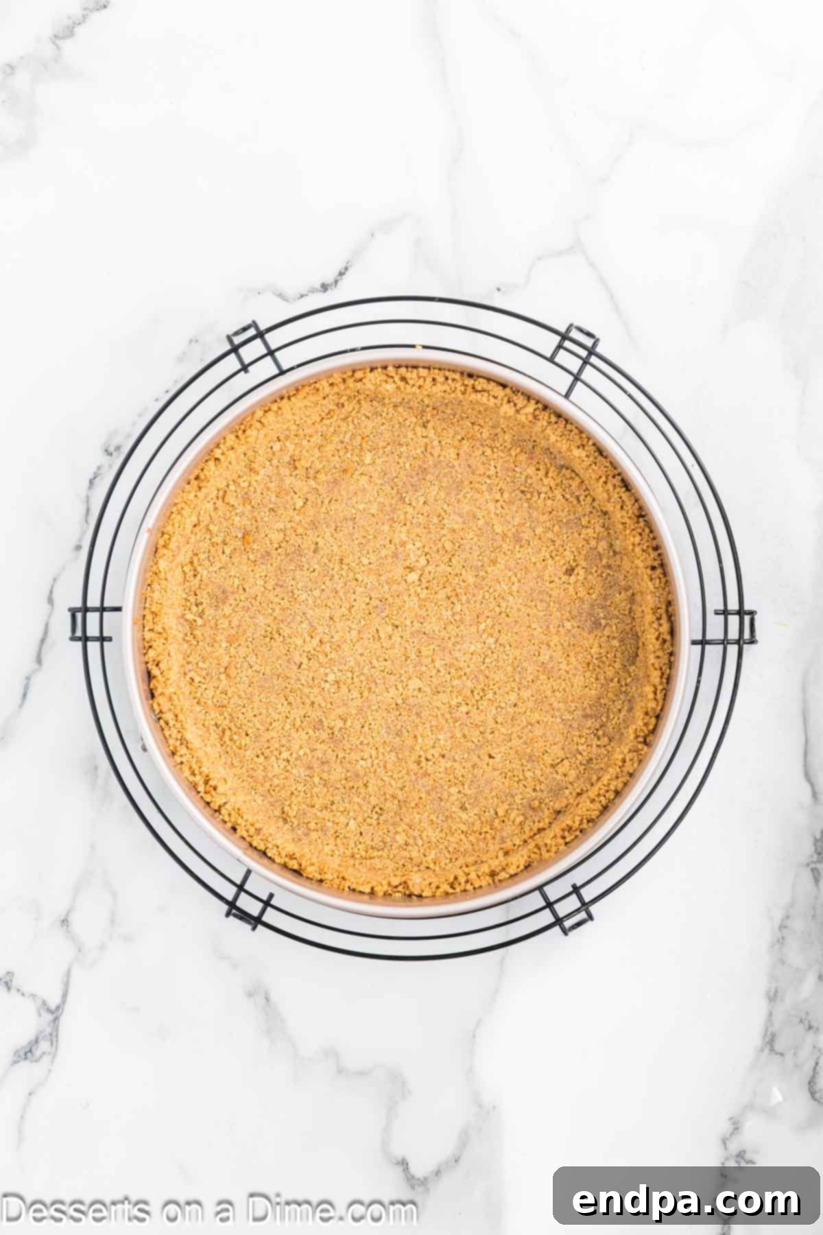 Heavenly Lemon Blueberry Cheesecake 4 The graham cracker crust mixture is pressed firmly into the bottom and slightly up the sides of a springform pan, creating an even base.