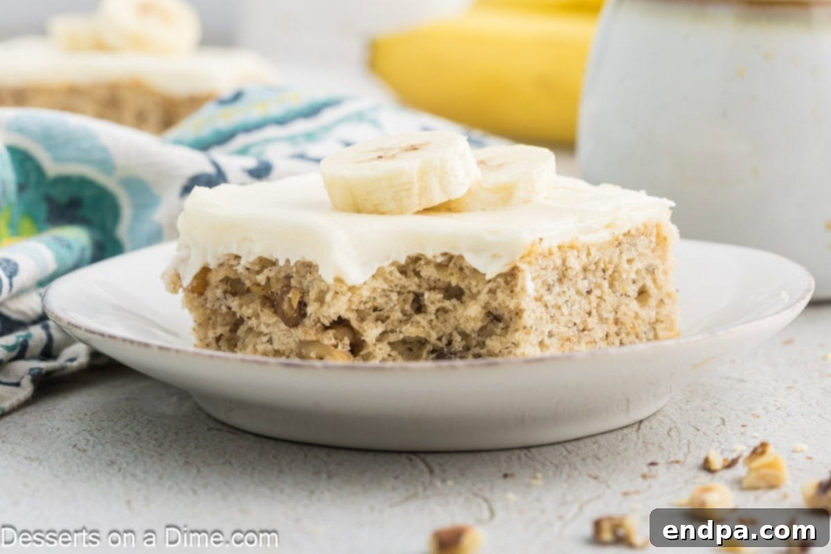 Ultimate Banana Bars 2 Banana Bar cut into bars and served on a white plate, showcasing the fluffy texture and creamy frosting.