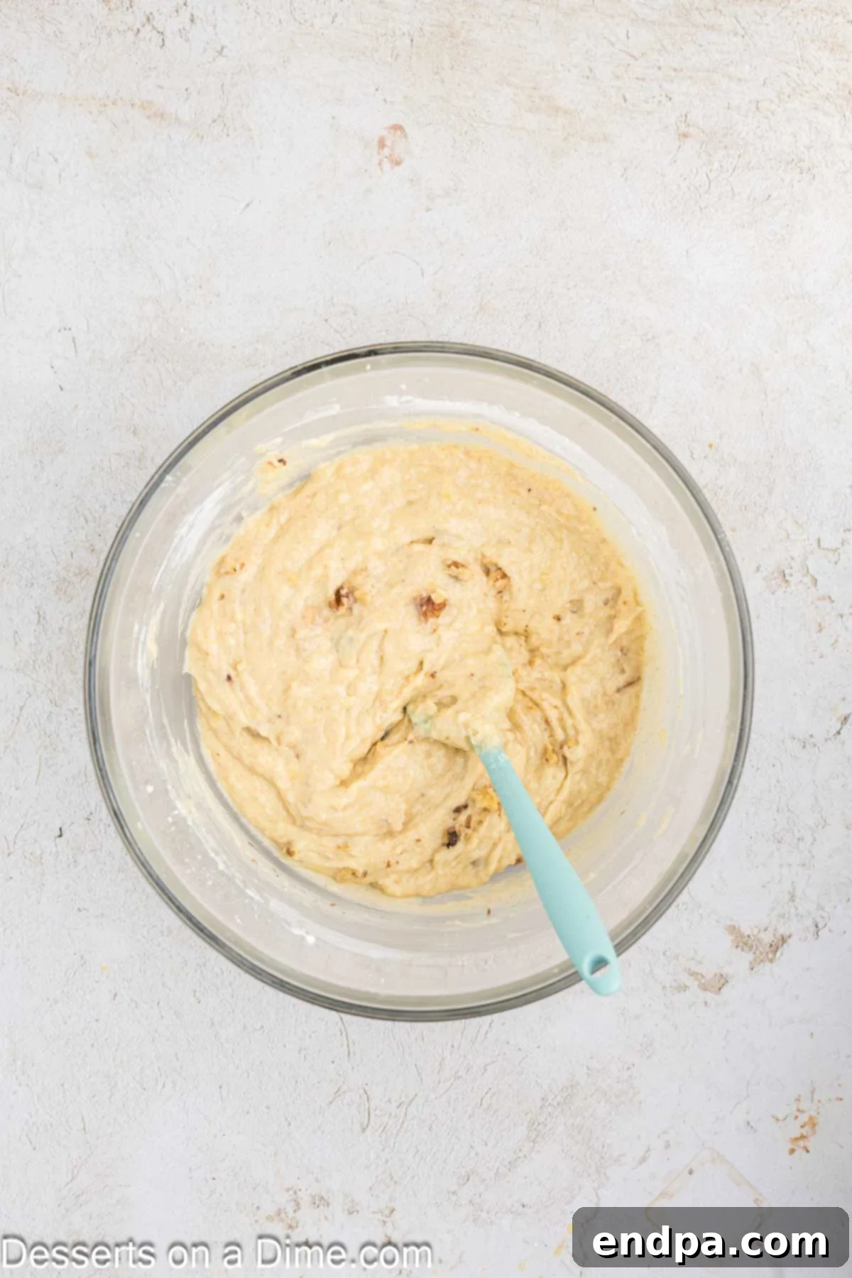Ultimate Banana Bars 5 Wet ingredients (eggs, mashed bananas, and milk) being mixed into the creamed butter and sugar mixture.