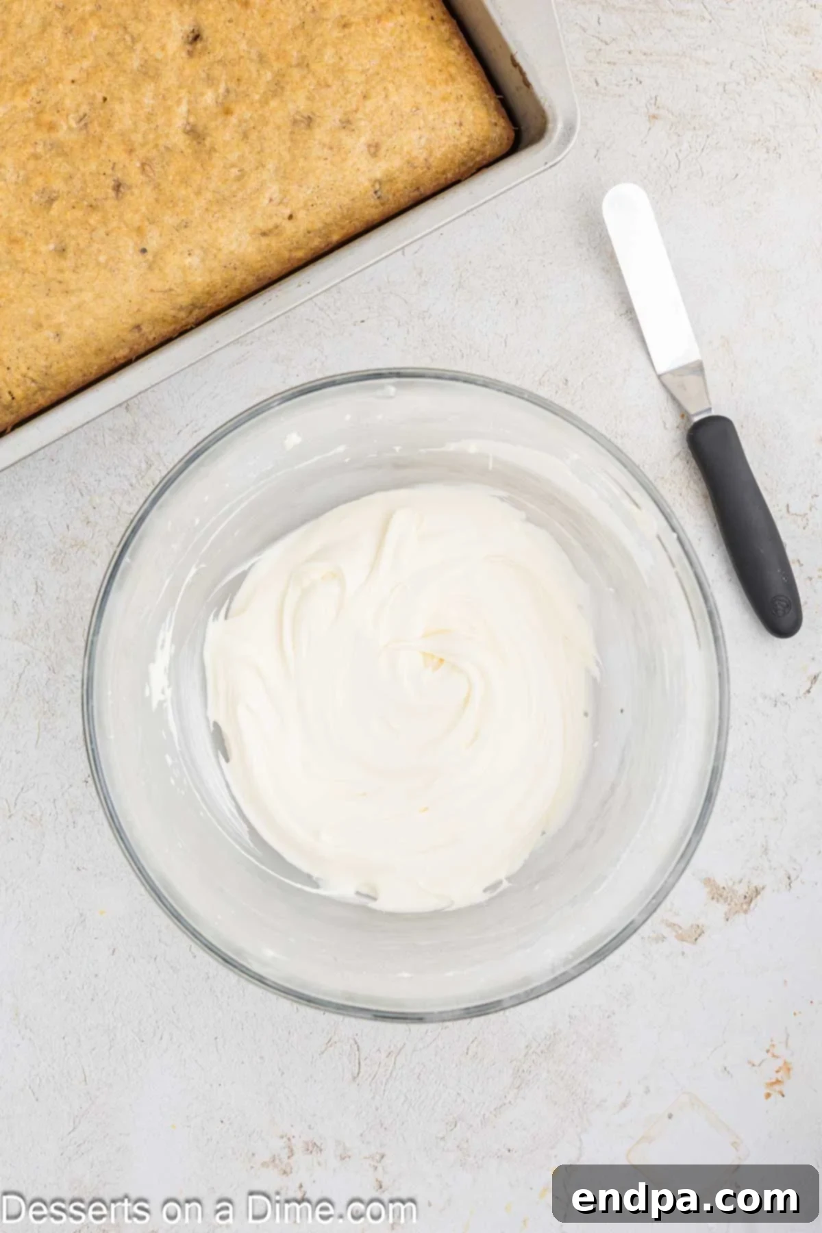 Ultimate Banana Bars 9 Powdered sugar being gradually mixed into the cream cheese and butter mixture for the frosting.