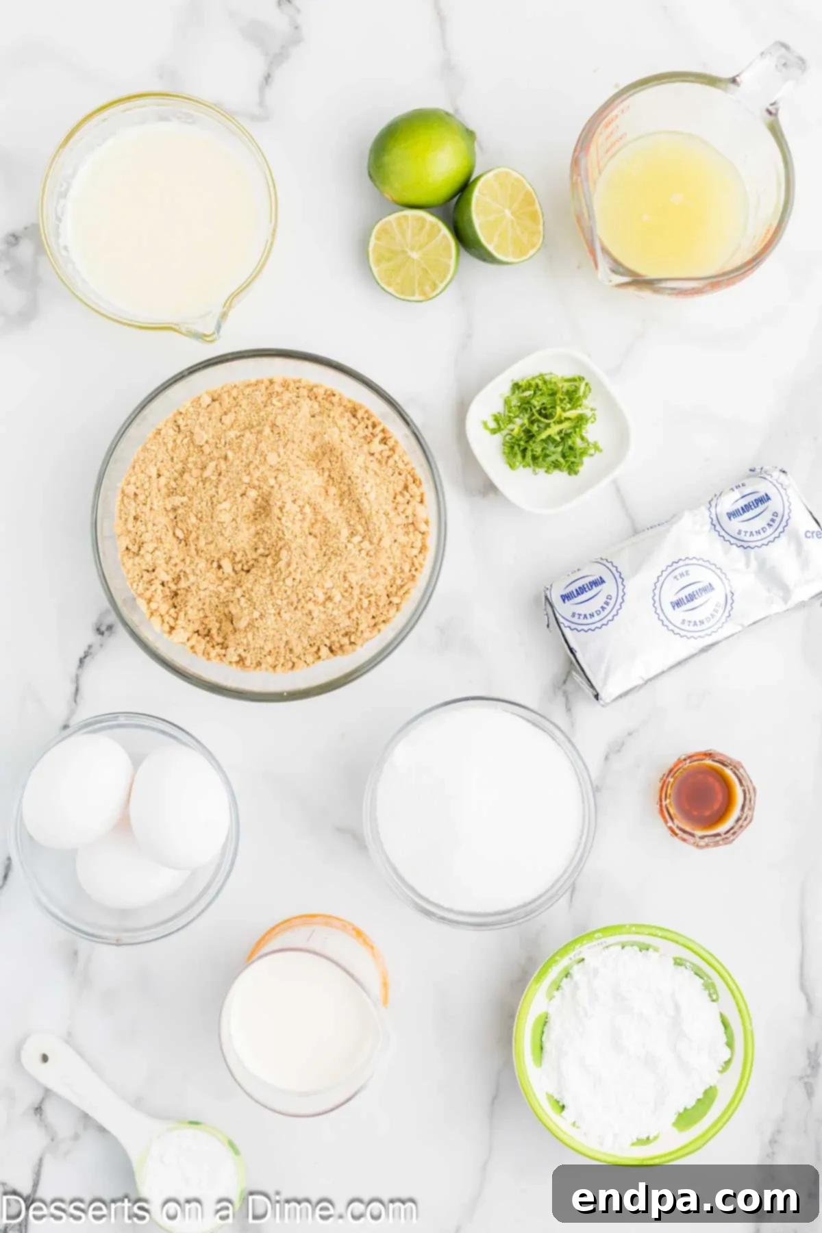 Ingredients for Key Lime Cheesecake: graham cracker crumbs, granulated sugar, melted butter, softened cream cheese, cornstarch, lime zest, key lime juice, large eggs, heavy cream, powdered sugar, and vanilla extract.