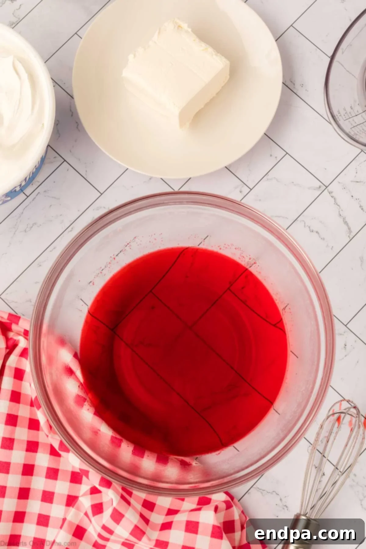 Layered Gelatin Delight 4 Red Jello mixture in a glass bowl, ready for the first layer of the parfait.