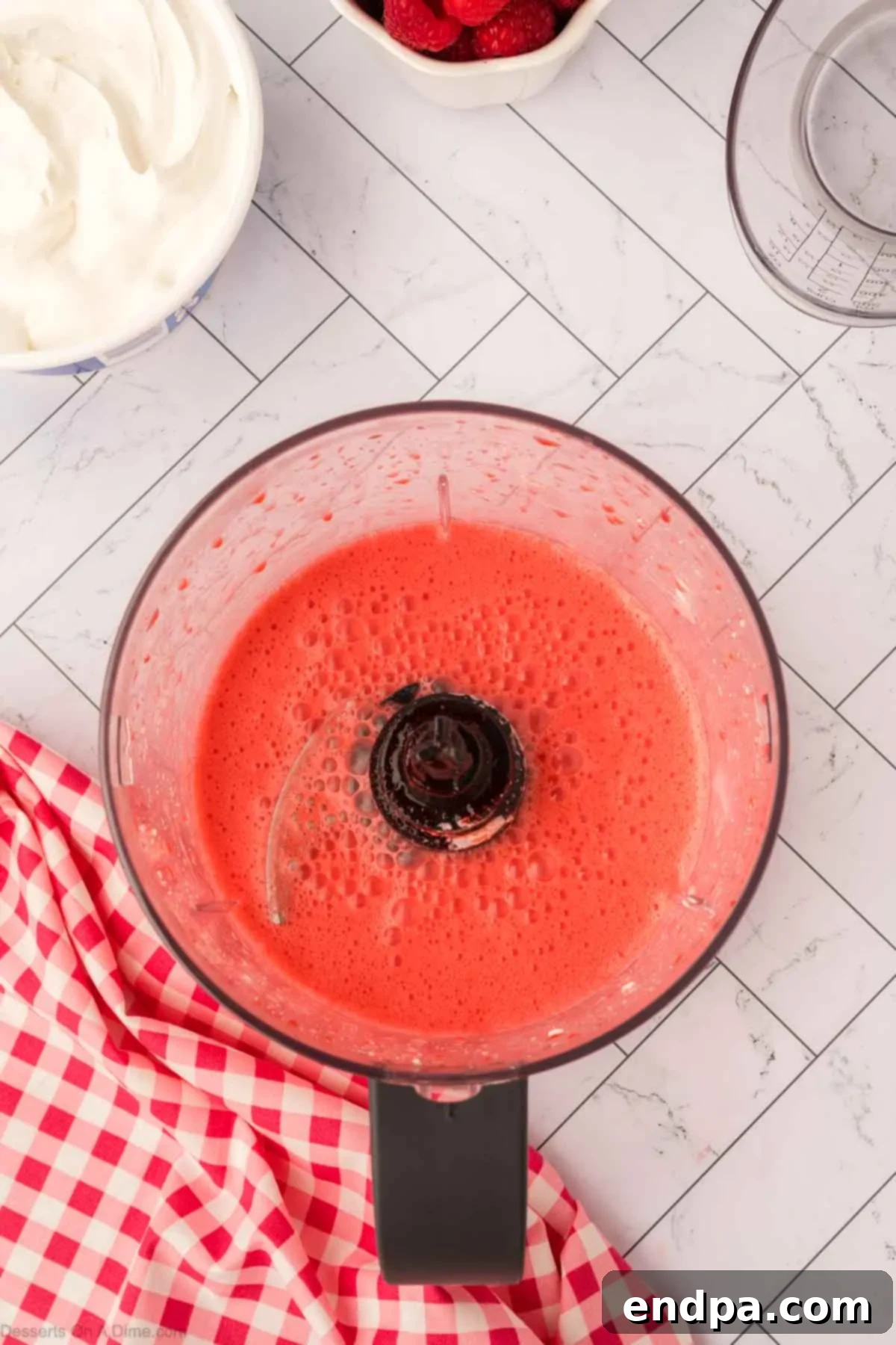 Layered Gelatin Delight 7 The blended mixture of Jello and cream cheese, appearing smooth and creamy.