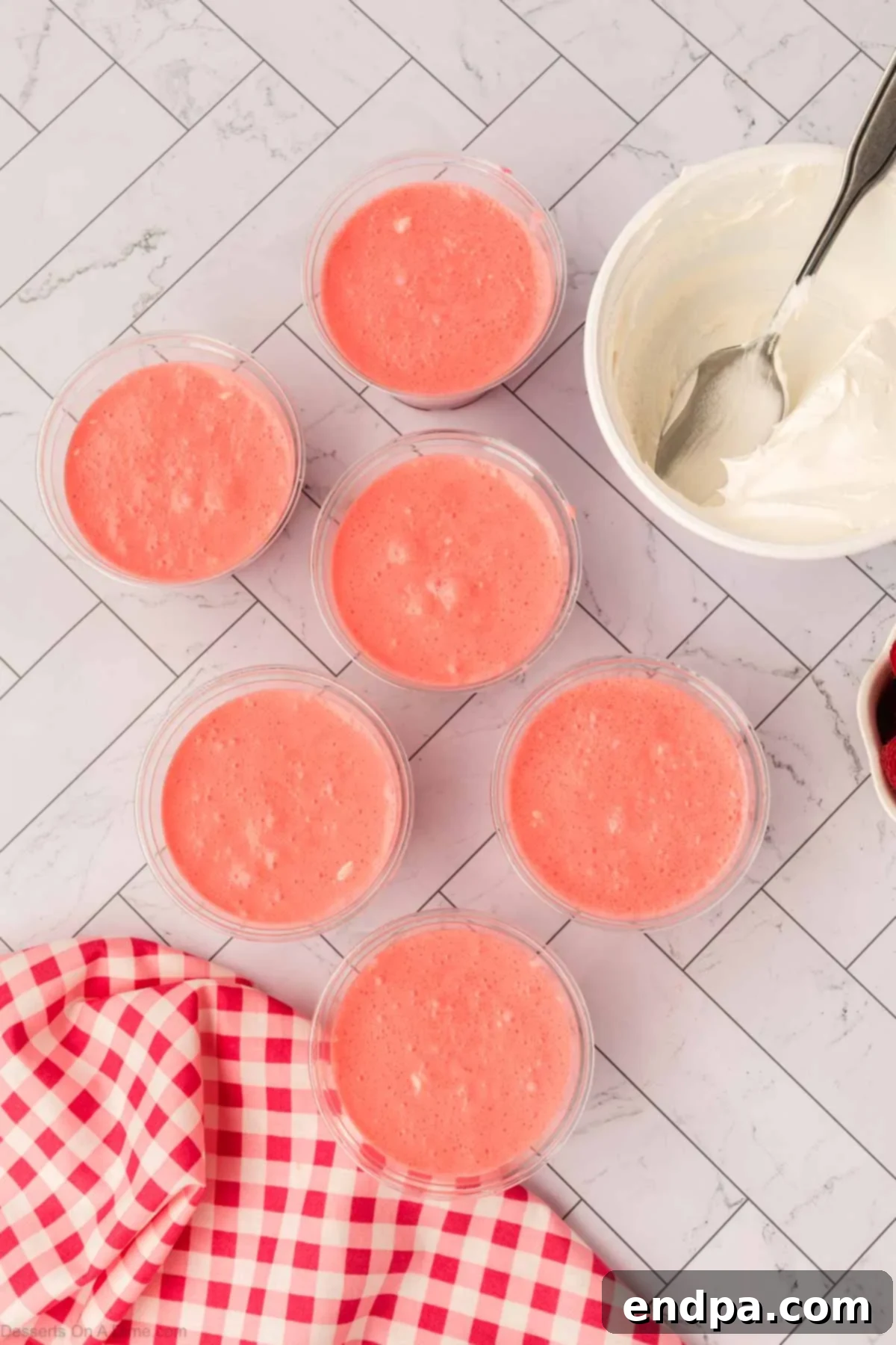 Layered Gelatin Delight 10 The creamy Jello mixture spooned over the set Jello in individual cups, forming the second layer.