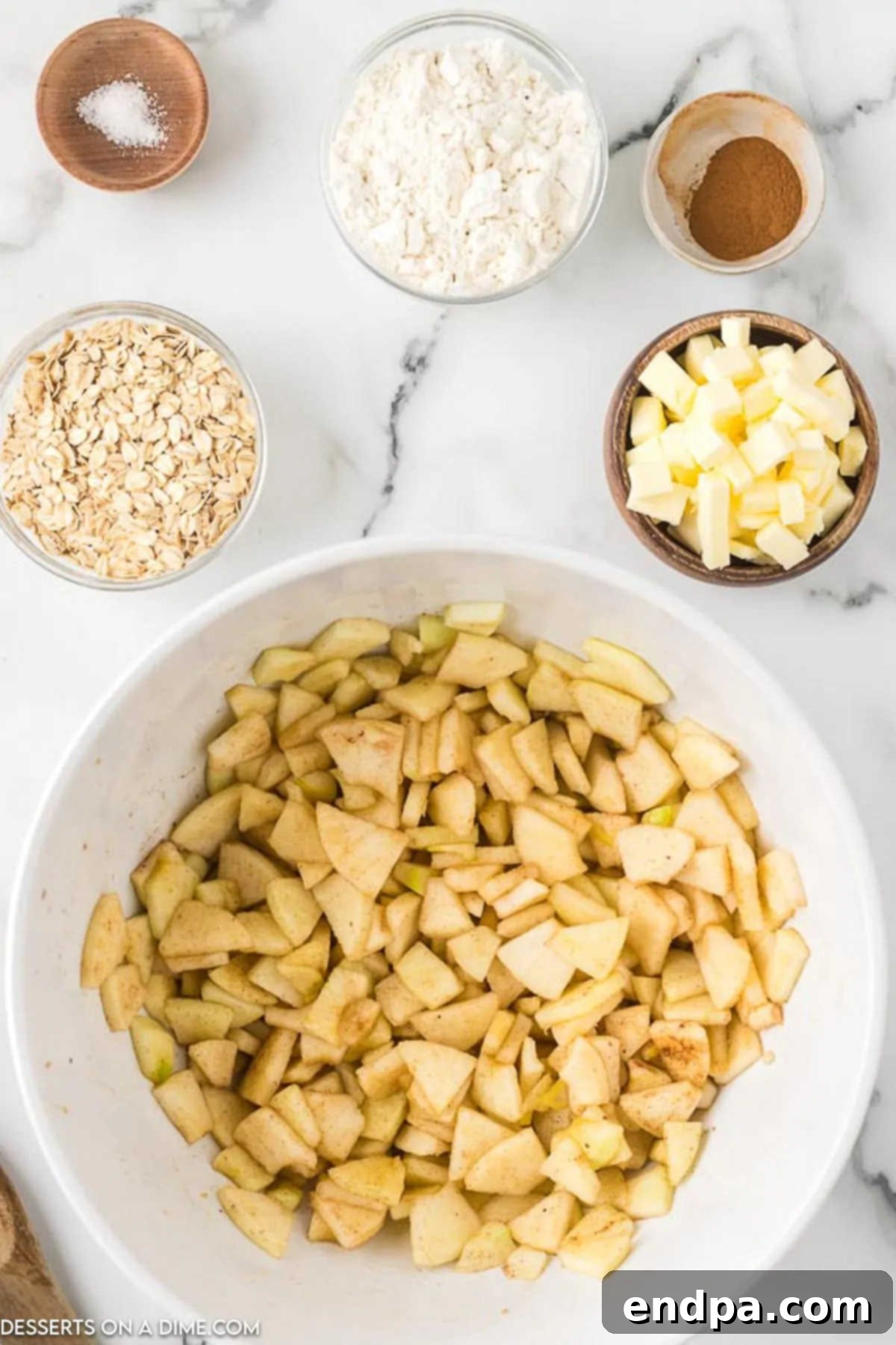 Buttery Oat Apple Crisp 4 Sliced apples in a bowl ready to be mixed.