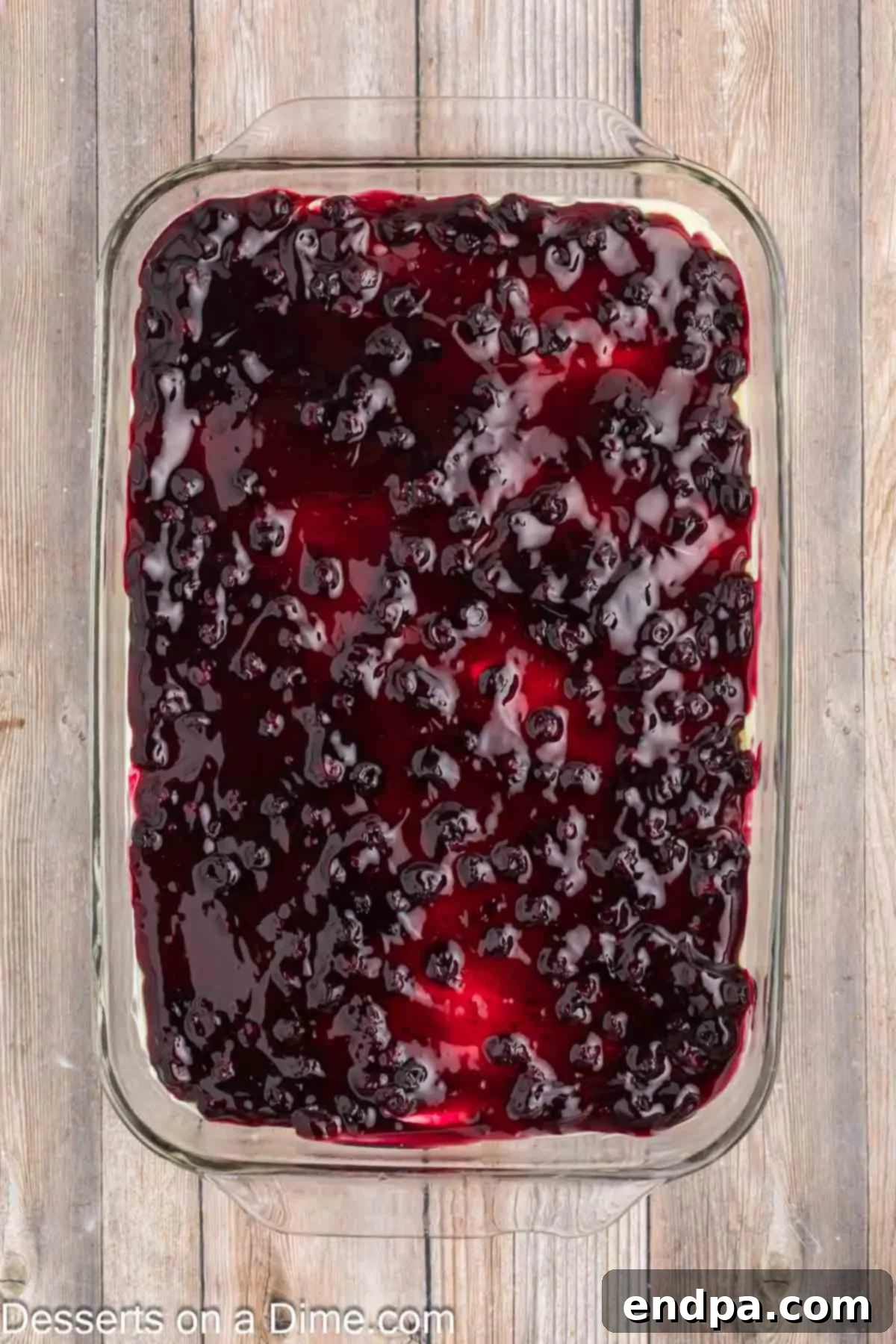Blueberry pie filling spread over pan.