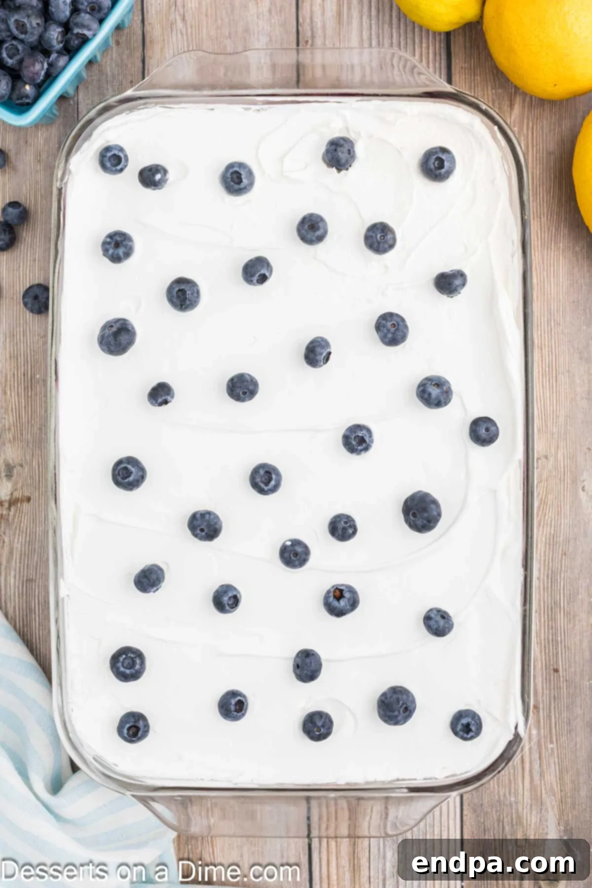Whipped cream spread on top and fresh blueberries sprinkled all over.