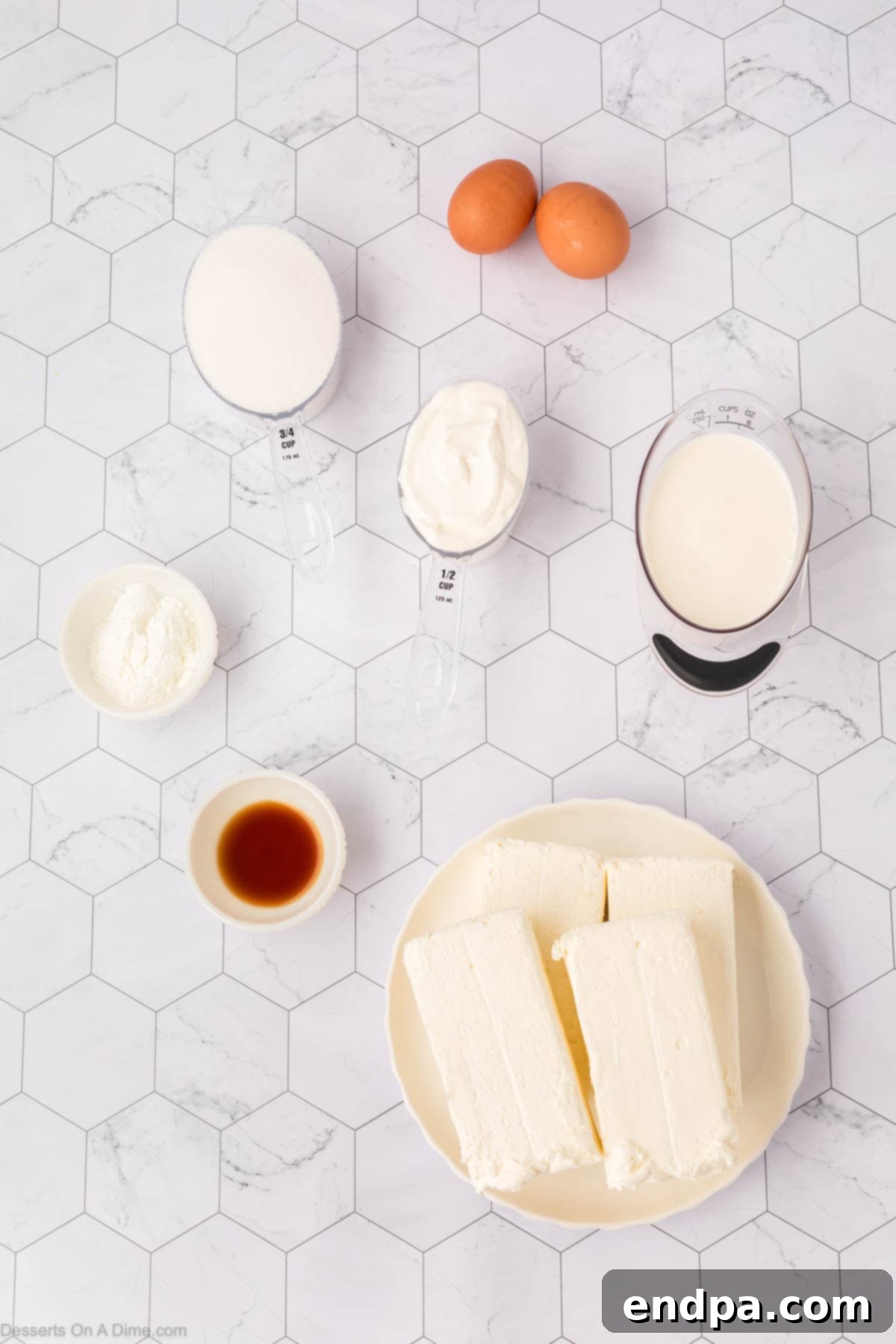 A flat lay photograph showcasing the key ingredients for S'mores Cheesecake, including graham cracker crumbs, brown sugar, butter, cream cheese blocks, chocolate chips, mini marshmallows, and sour cream, all neatly arranged.