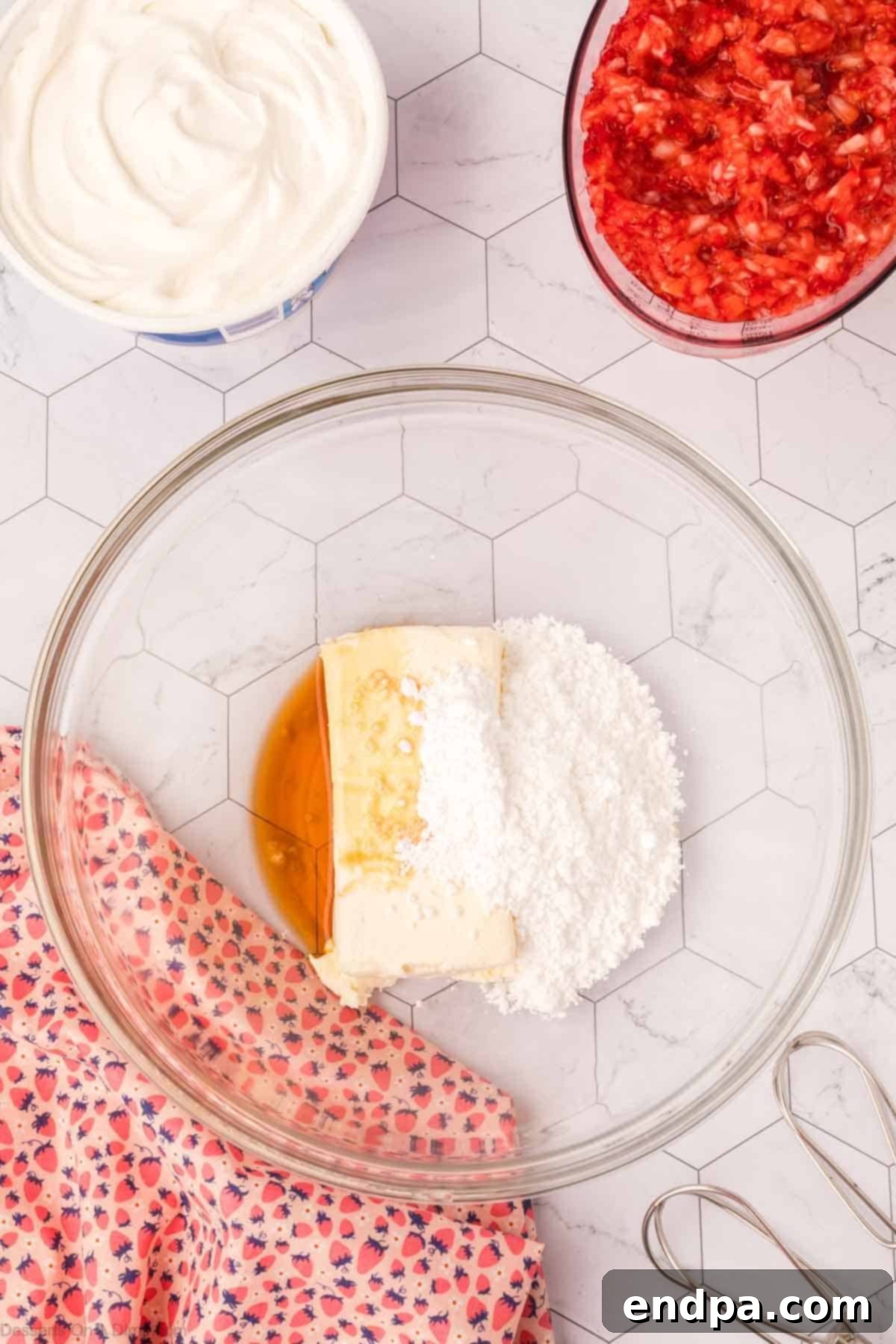 Cheesecake Cloud 4 A bowl with softened cream cheese, powdered sugar, and vanilla extract, ready to be beaten.