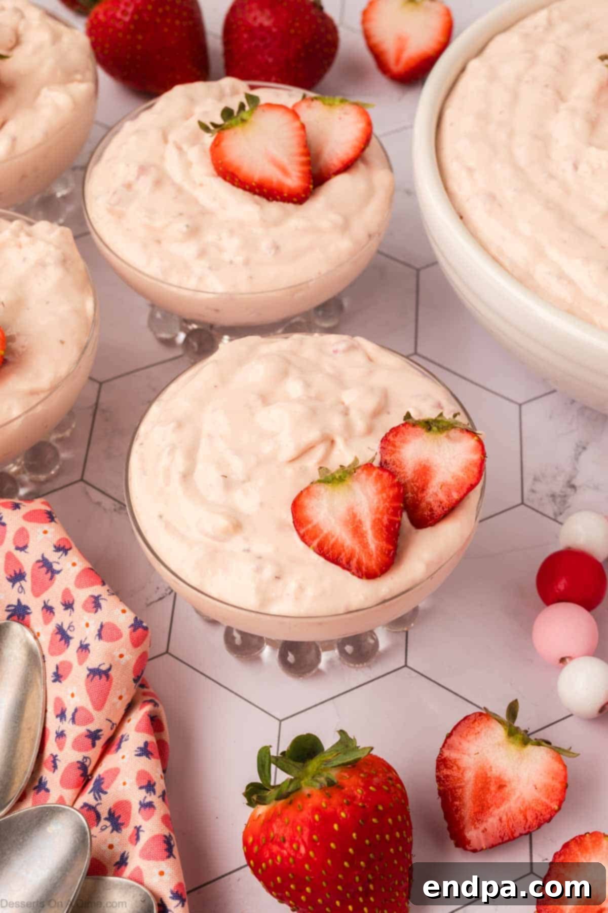 Cheesecake Cloud 8 A large bowl of finished Cheesecake Fluff, garnished with whole fresh strawberries.