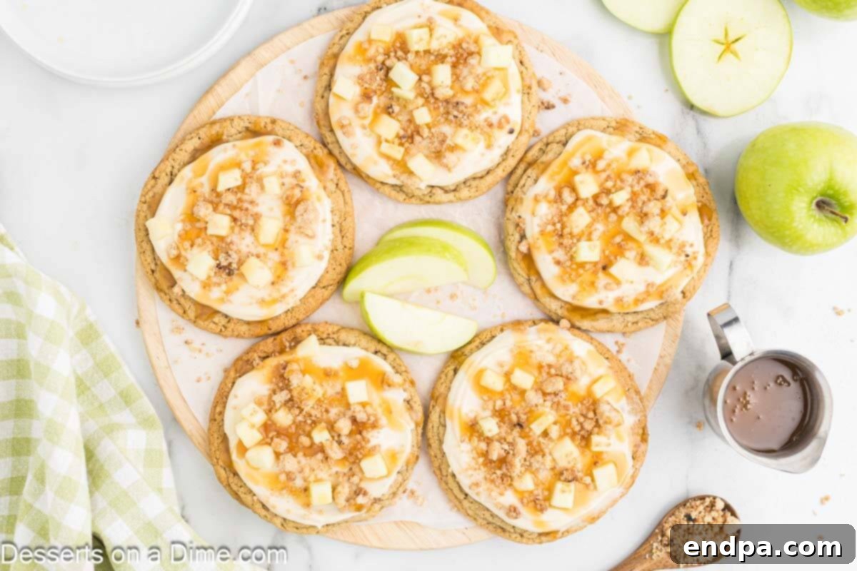Caramel apple cookies arranged in a circle, showcasing their soft texture, frosting, diced apples, and streusel topping.