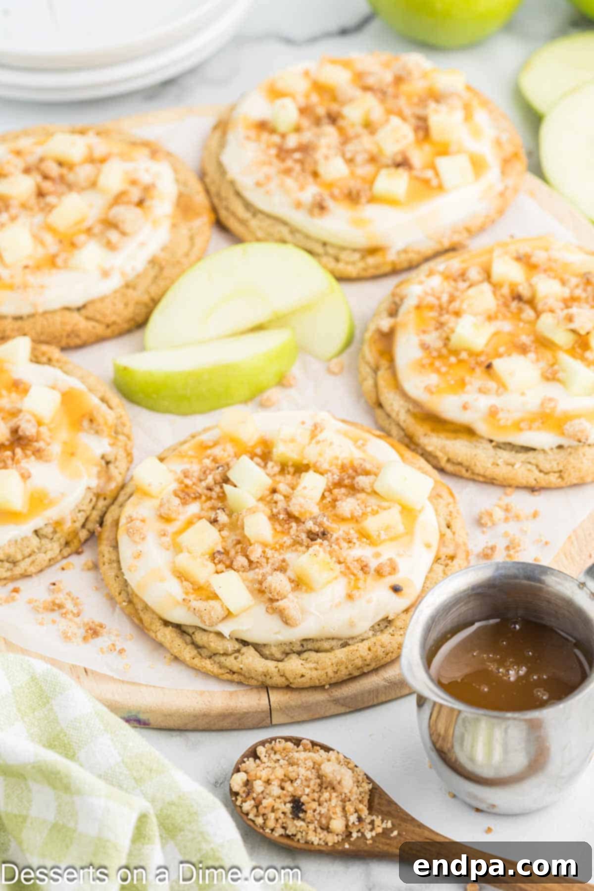 A close-up of a plate of perfectly baked and decorated Caramel Apple cookies, ready for serving.