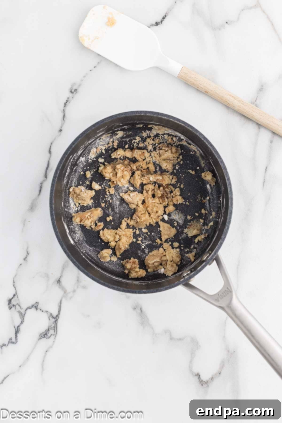Butter melting in a skillet, ready for streusel preparation.