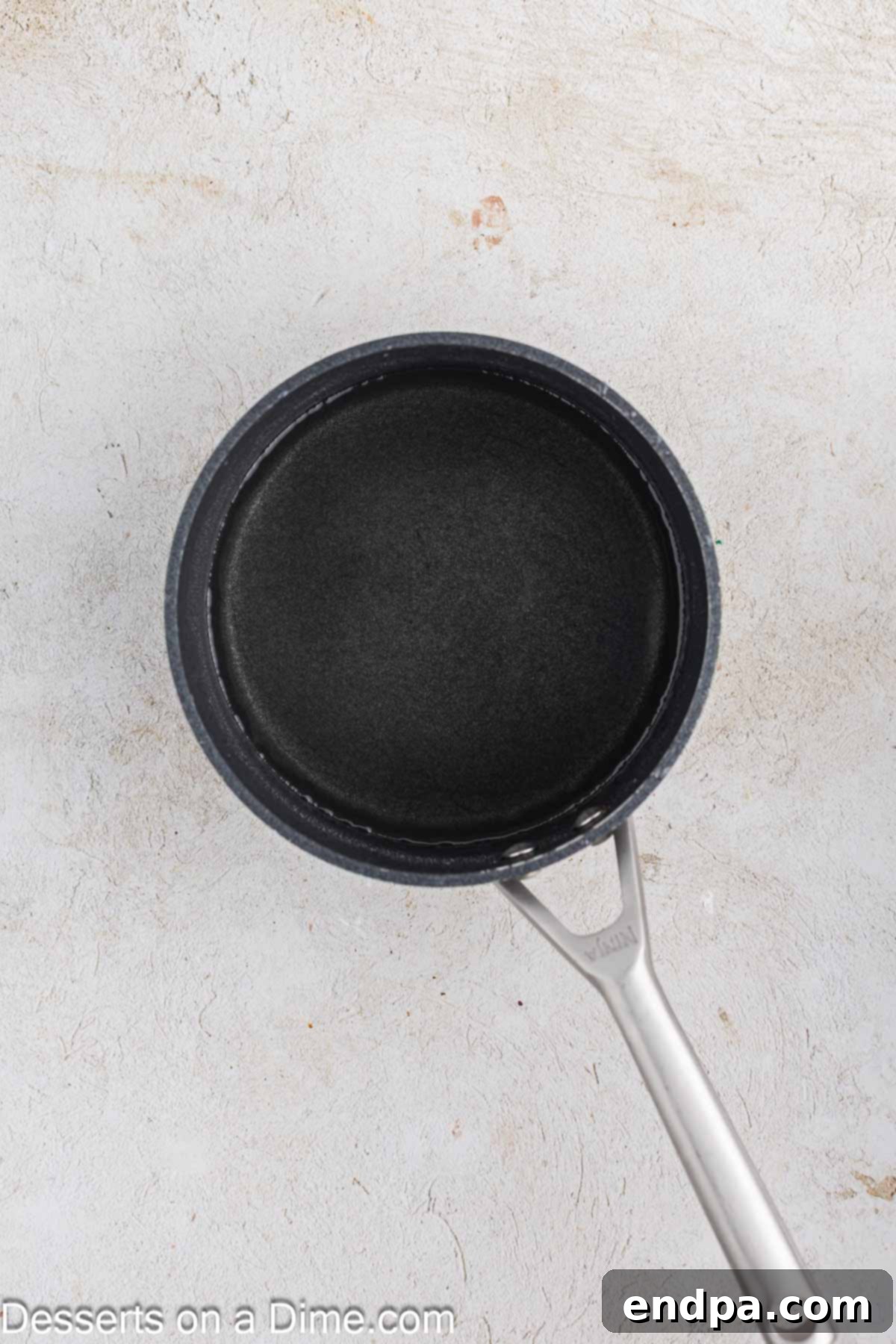 Simple syrup mixture simmering in a small saucepan on the stove.