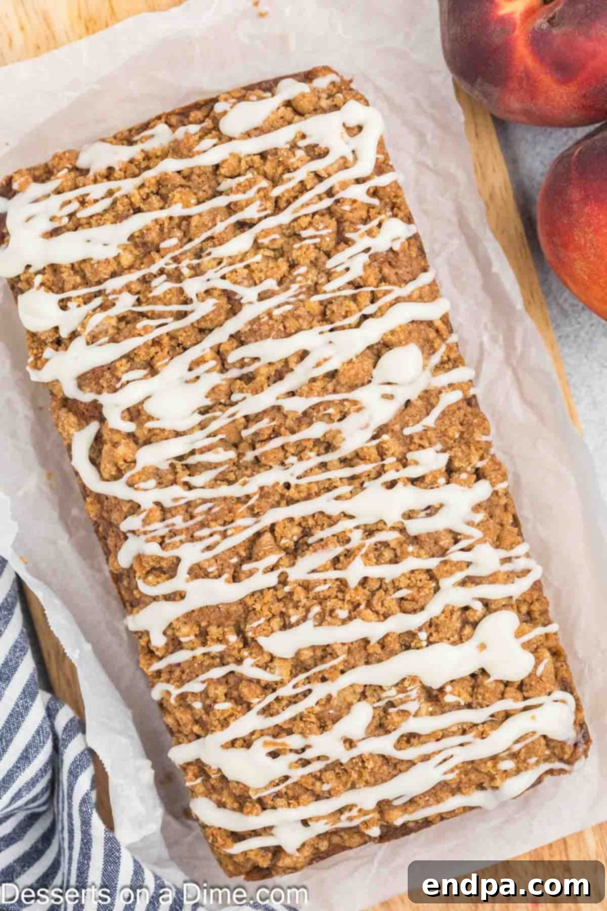 A perfectly baked, glazed Peach Bread, sliced and beautifully arranged on a serving platter, ready for guests to enjoy.