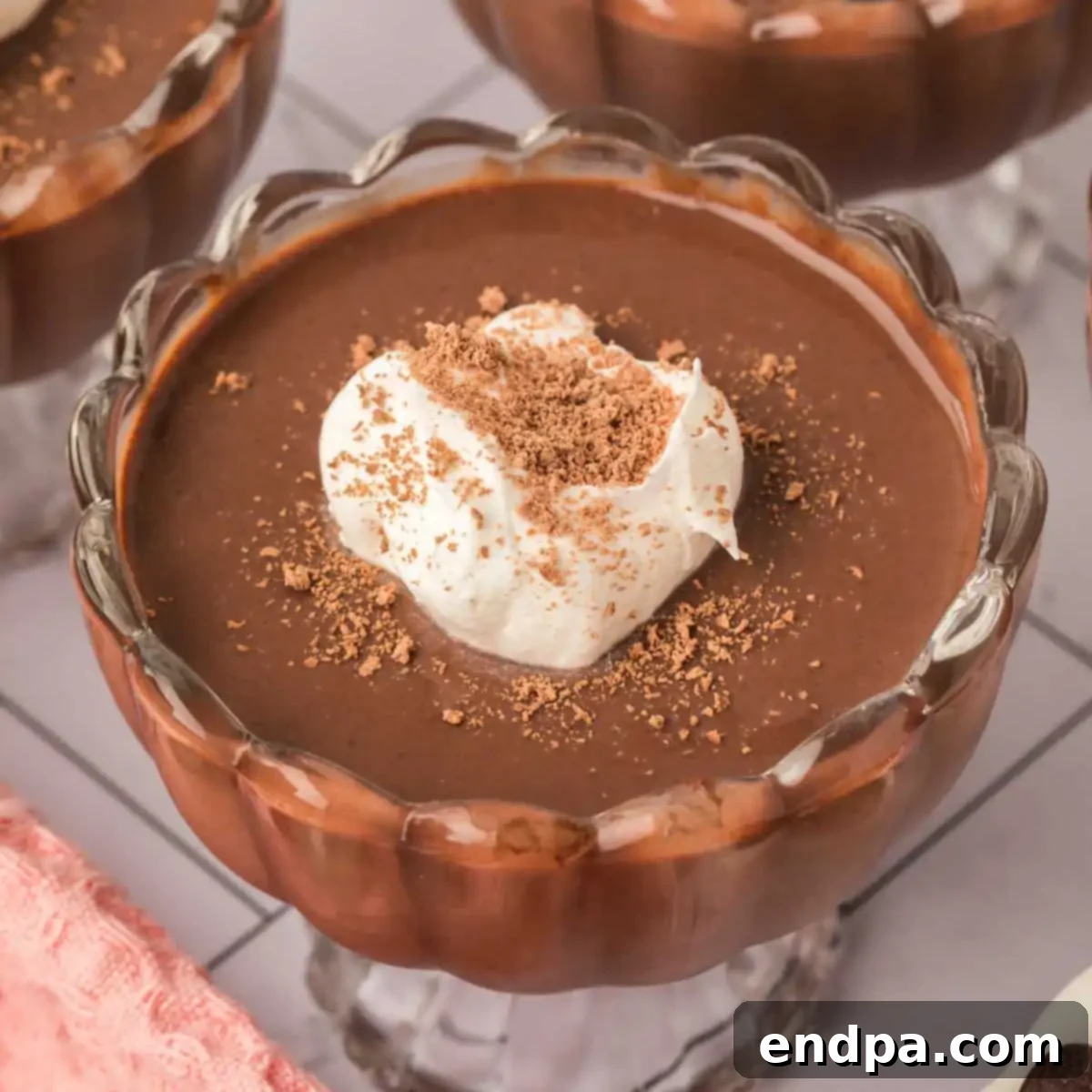 Velvety Dark Chocolate Pudding 9 Dark Chocolate Pudding in cups with whipped cream.