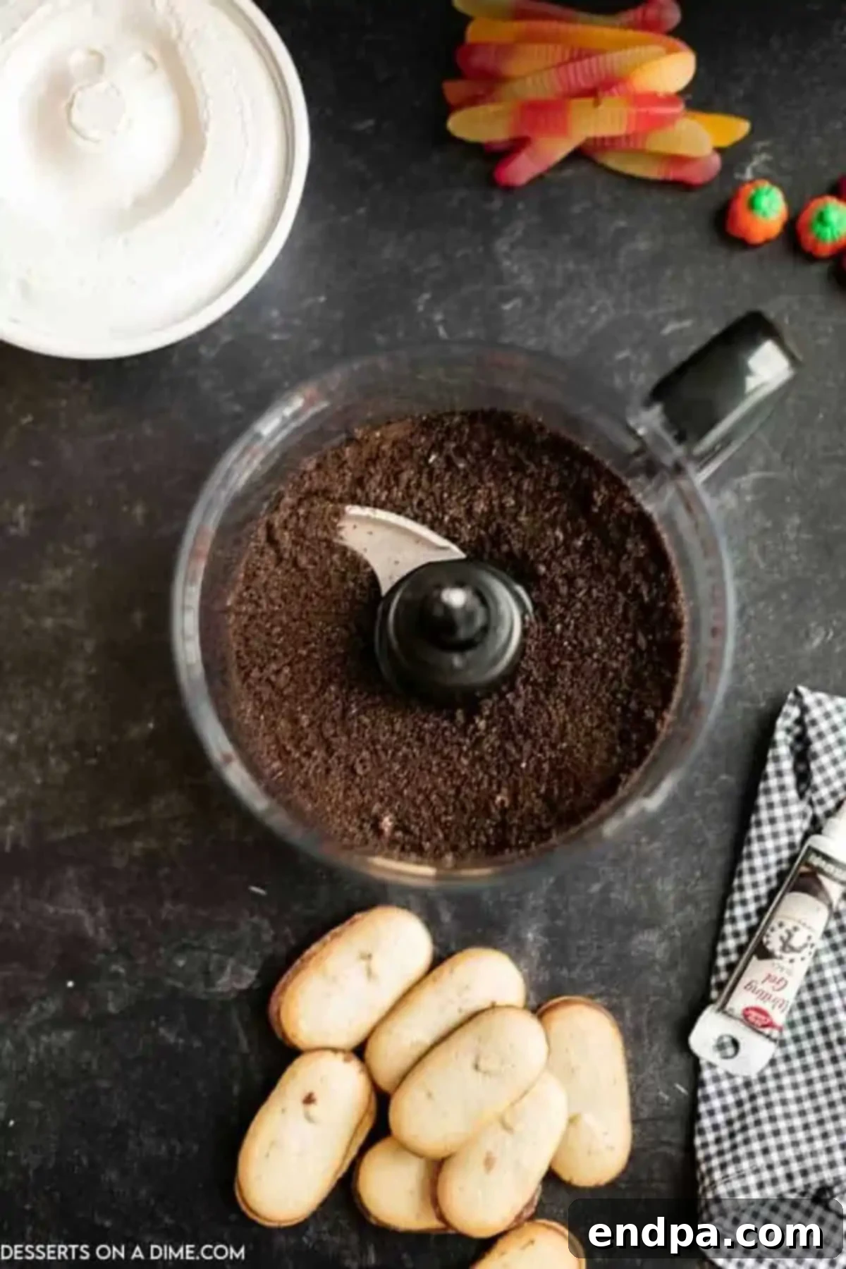 Oreo cookies being crushed into fine crumbs in a food processor.