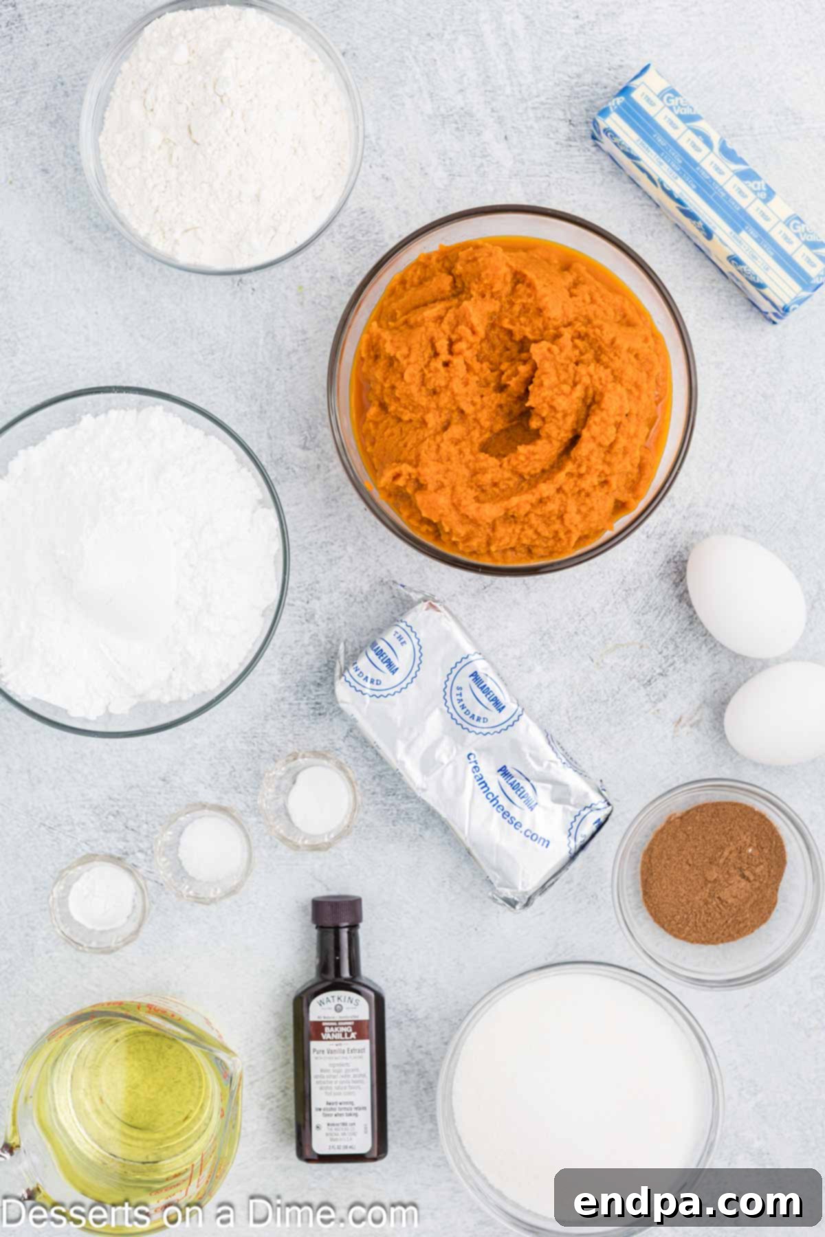 Autumn Pumpkin Cream Pies 3 All the essential ingredients for making pumpkin whoopie pies laid out neatly on a kitchen counter: flour, baking soda, baking powder, pumpkin pie spice, salt, sugar, vegetable oil, eggs, pumpkin puree, and vanilla extract for the cookies; butter, cream cheese, powdered sugar, and vanilla extract for the filling.