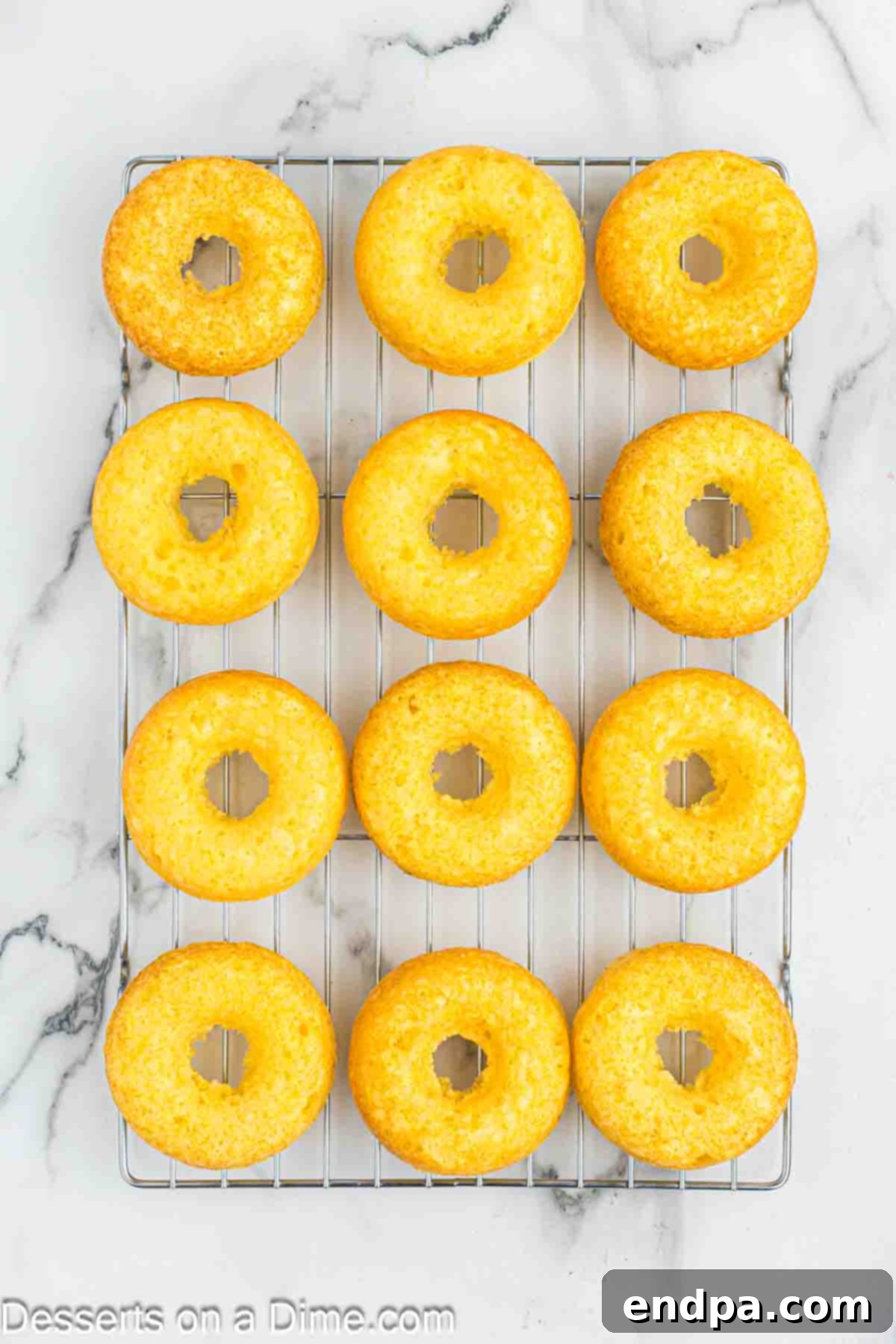 Donuts cooling on wire rack.