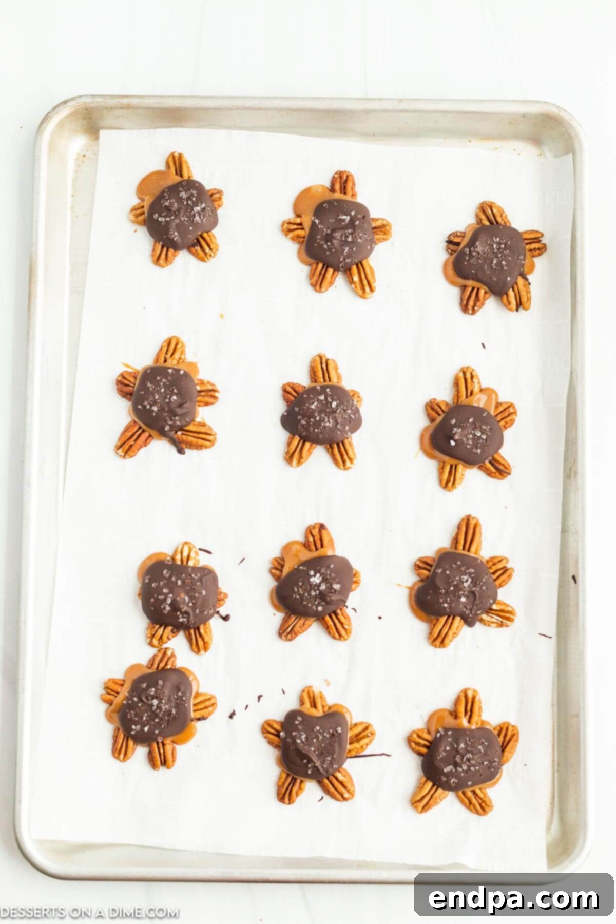 Melted chocolate on top of caramel with sea salt on top.