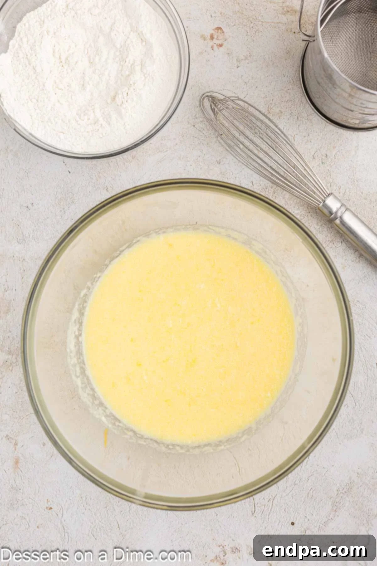 Wet ingredients for orange cranberry bread mixed in a large bowl, including Greek yogurt, melted butter, orange juice, eggs, vanilla, and sugar.