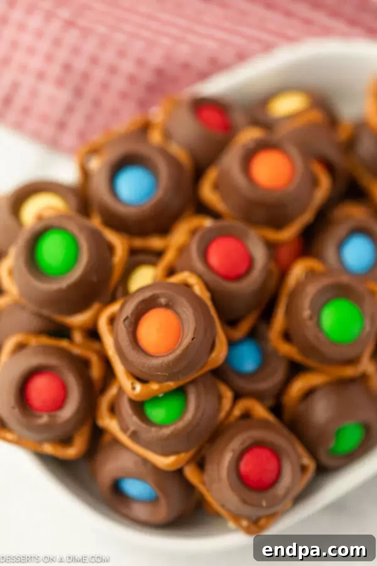 A large bowl brimming with freshly made Rolo Pretzel Bites, showcasing the vibrant colors of M&Ms.