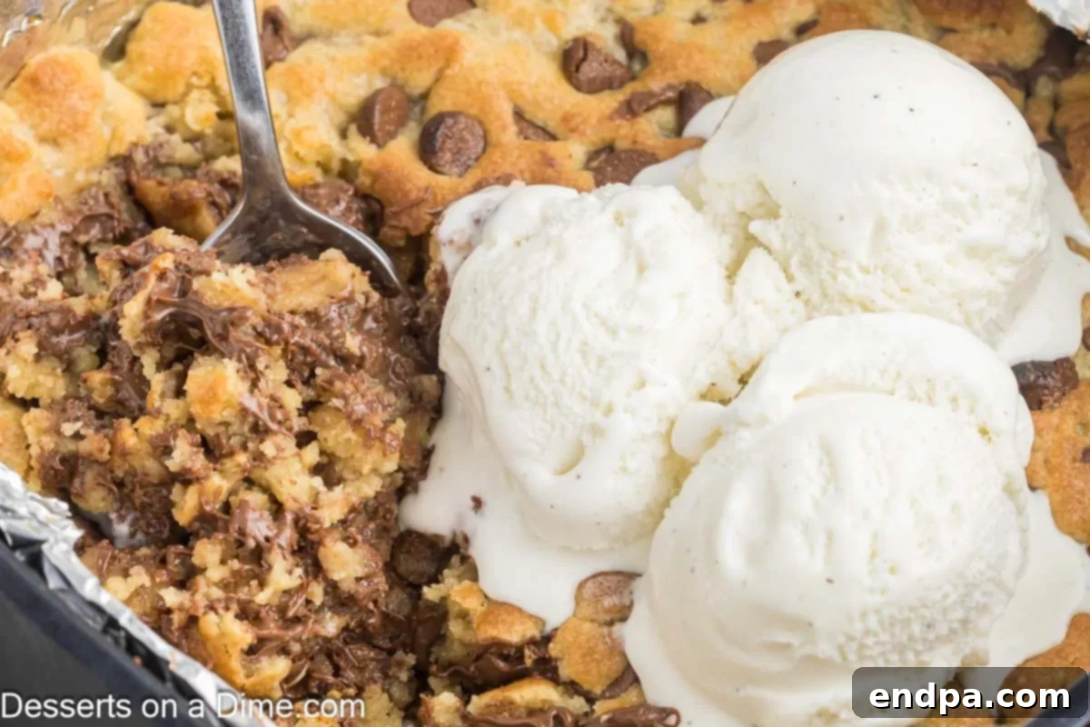Warm & Gooey Air Fryer Pizookie 2 A perfectly baked Air Fryer Pizookie generously topped with a scoop of vanilla ice cream, ready to be enjoyed.