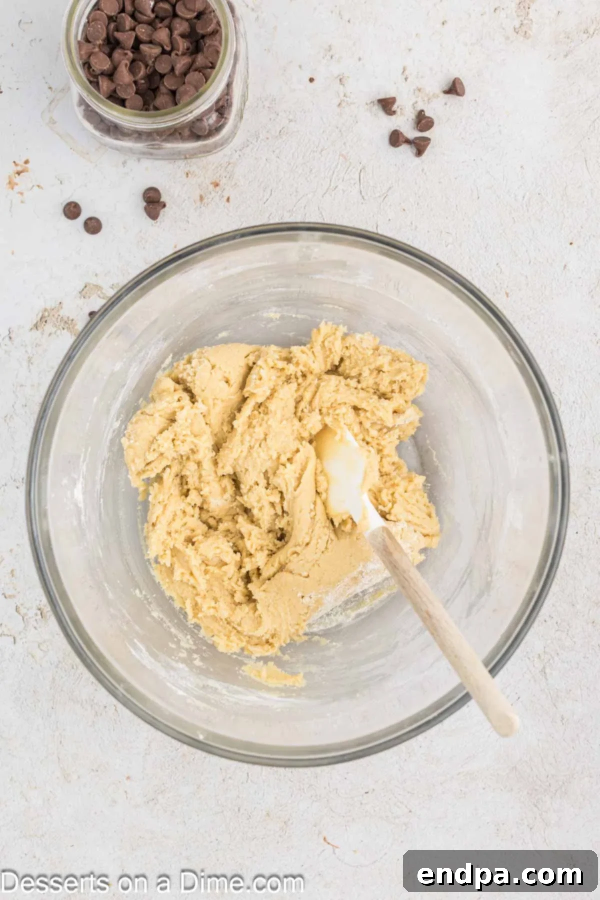 Warm & Gooey Air Fryer Pizookie 6 Dry ingredients being stirred into the wet ingredients to form cookie dough.