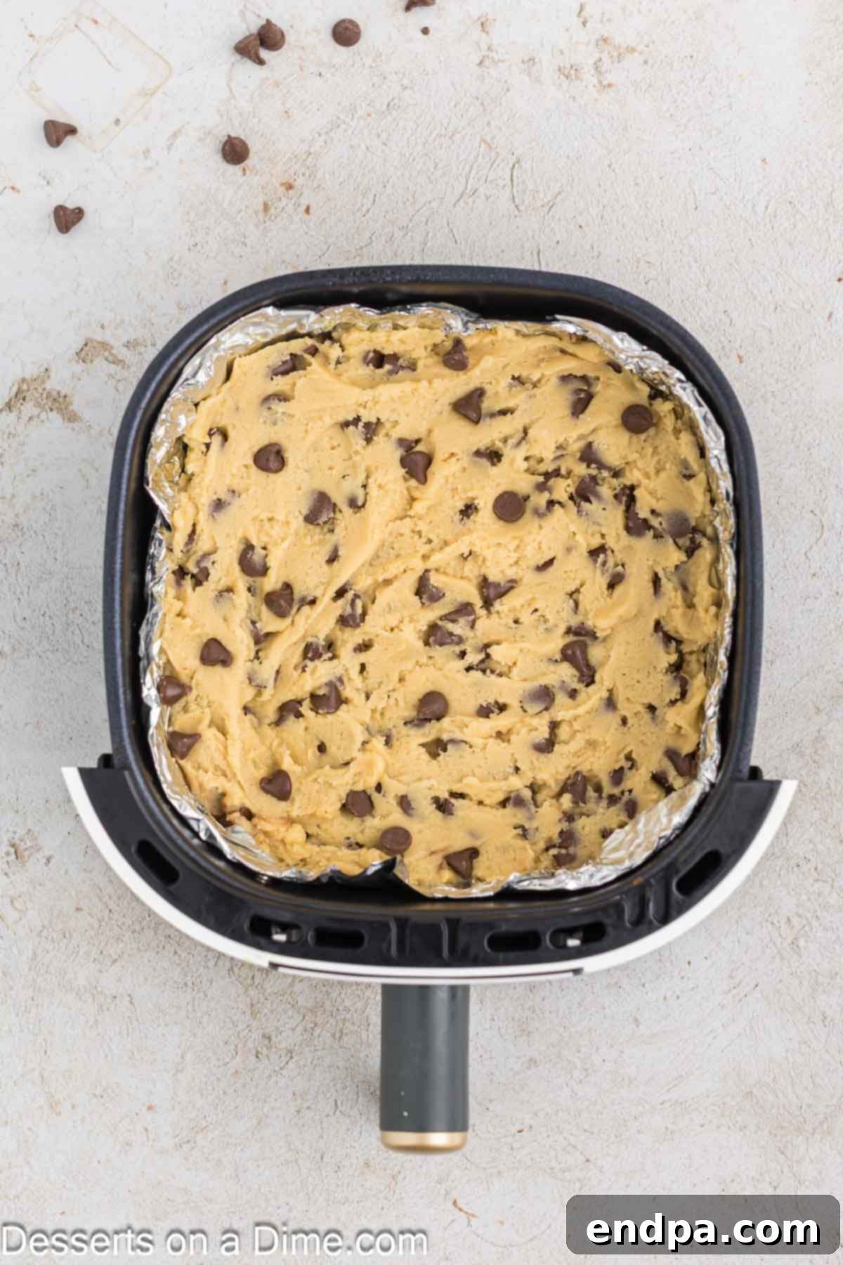 Warm & Gooey Air Fryer Pizookie 8 Chocolate chip cookie dough pressed firmly into the foil-lined air fryer basket.