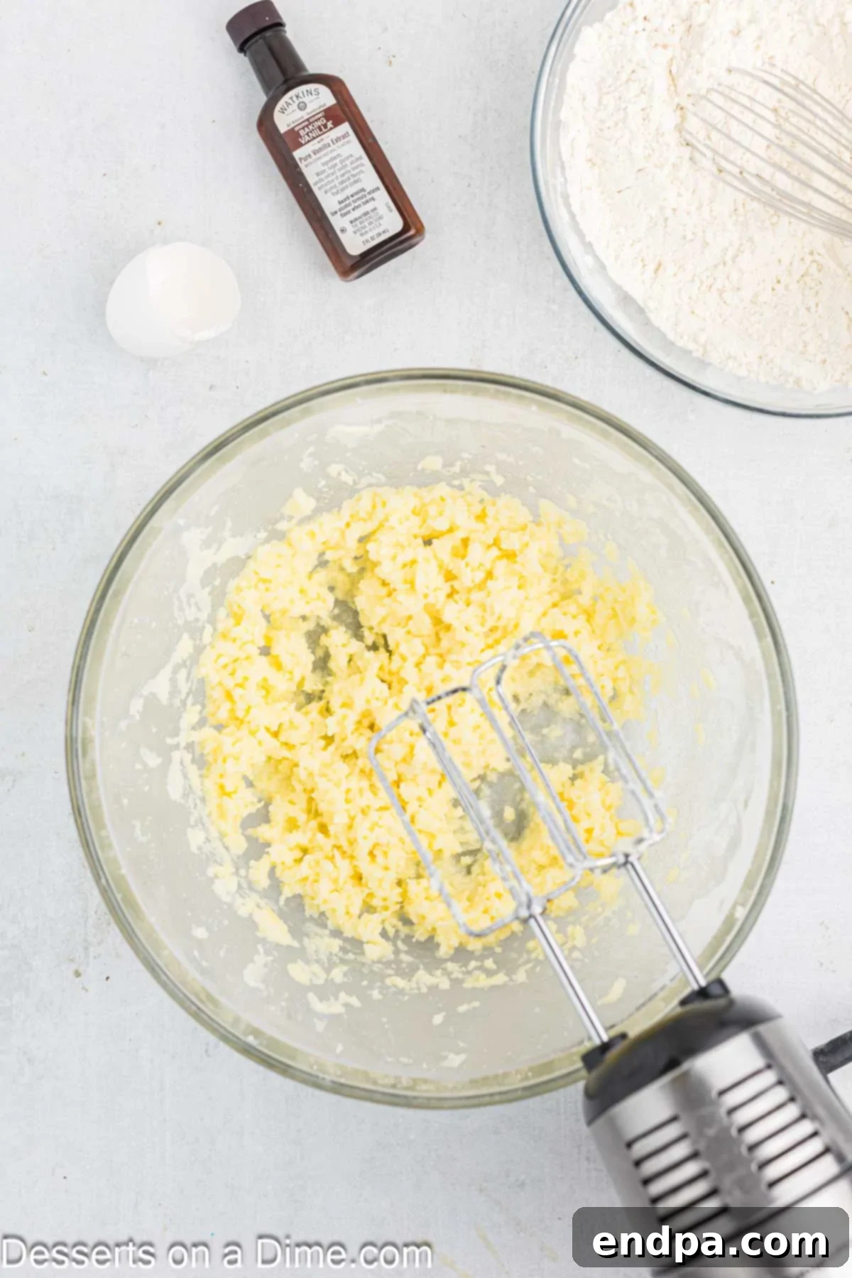 Crimson Cherry Thumbprint Cookies 4 Creamy butter and granulated sugar beaten together in a large mixing bowl, appearing light and fluffy.