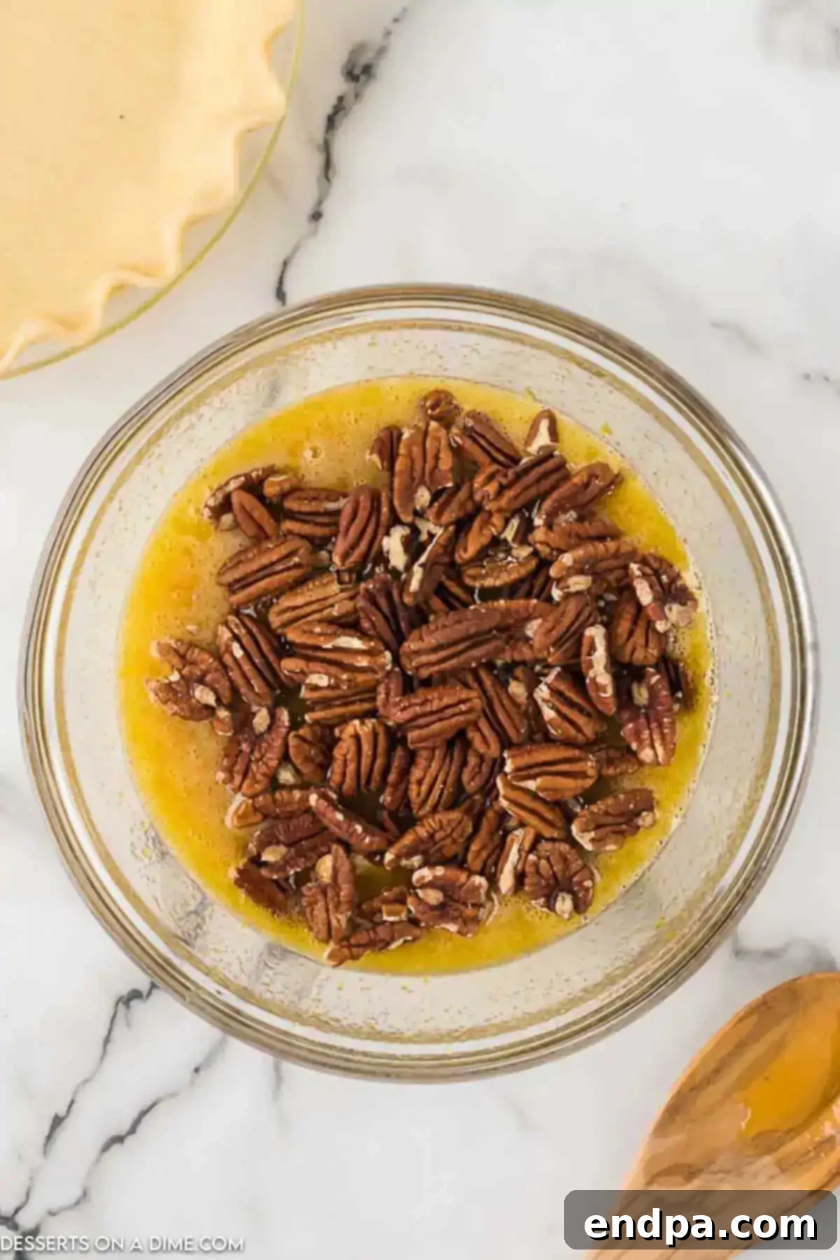 Gooey Chocolate Pecan Perfection 4 Pecans added to mixing bowl with egg and chocolate mixture.
