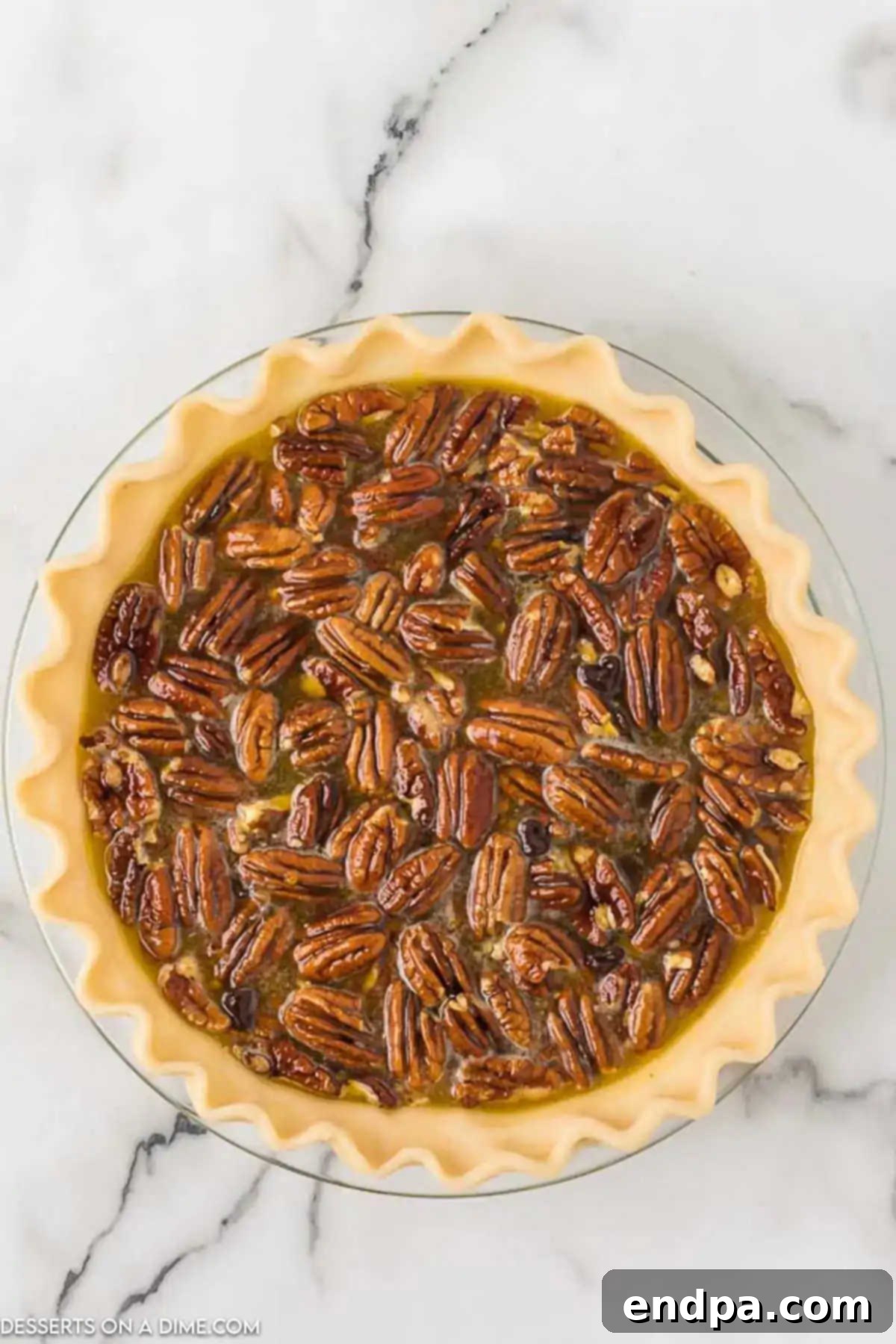 Gooey Chocolate Pecan Perfection 5 Pie mixture poured into an unbaked pie crust.