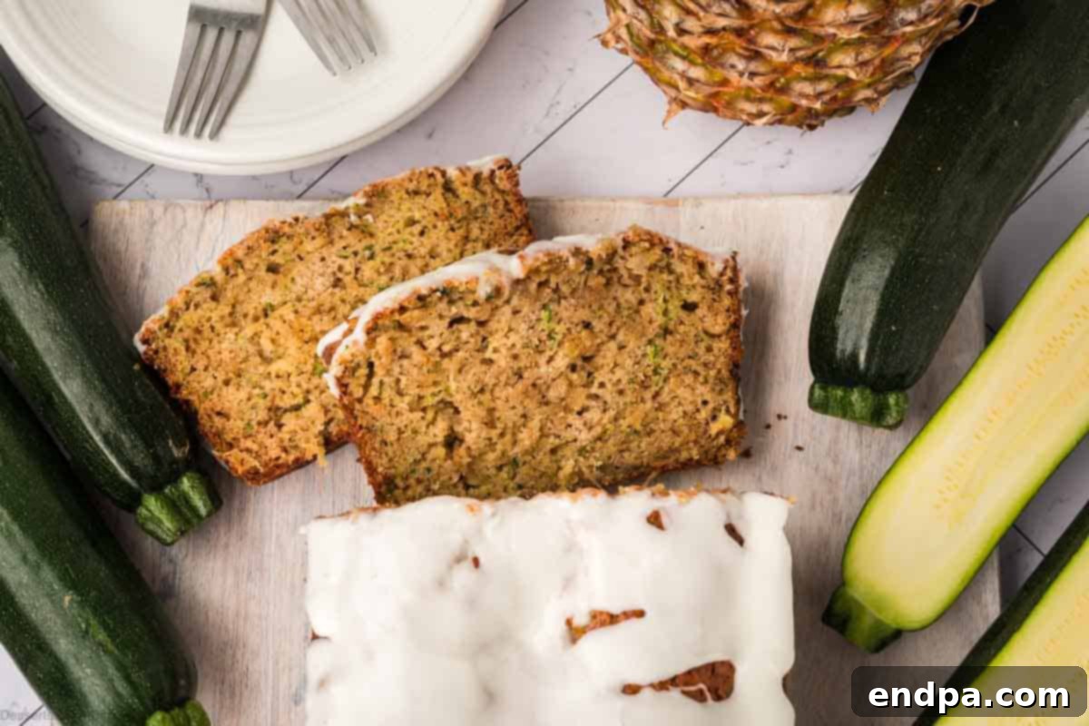 Slices of moist zucchini bread with pineapple, garnished and ready to be served.