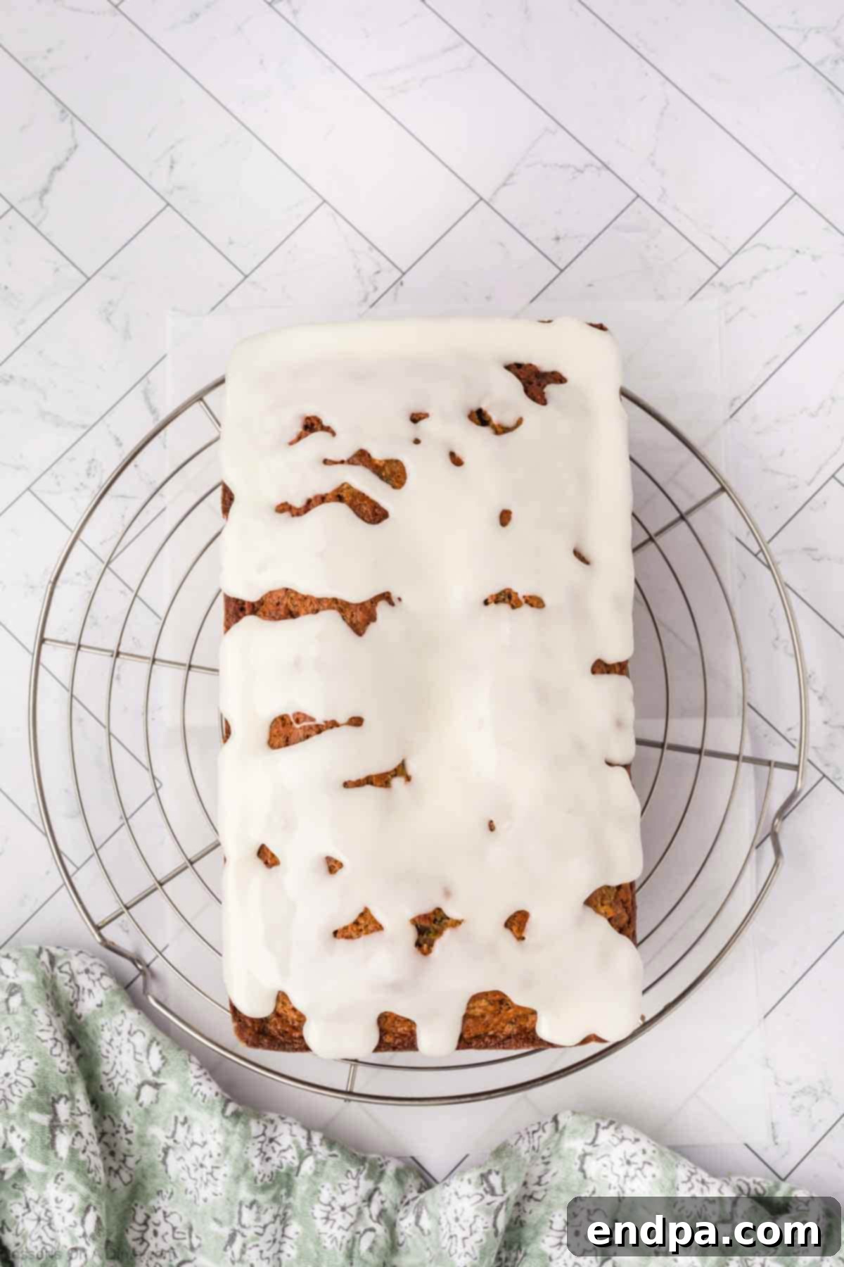 The cooled zucchini pineapple bread on a wire rack, beautifully drizzled with the sweet pineapple glaze.