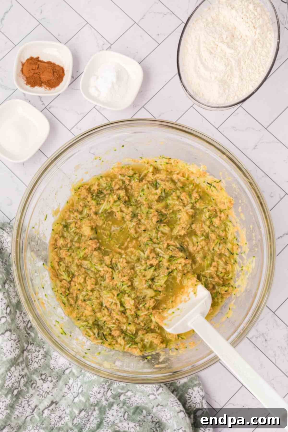 The fully combined batter for zucchini pineapple bread, showing an even distribution of ingredients.