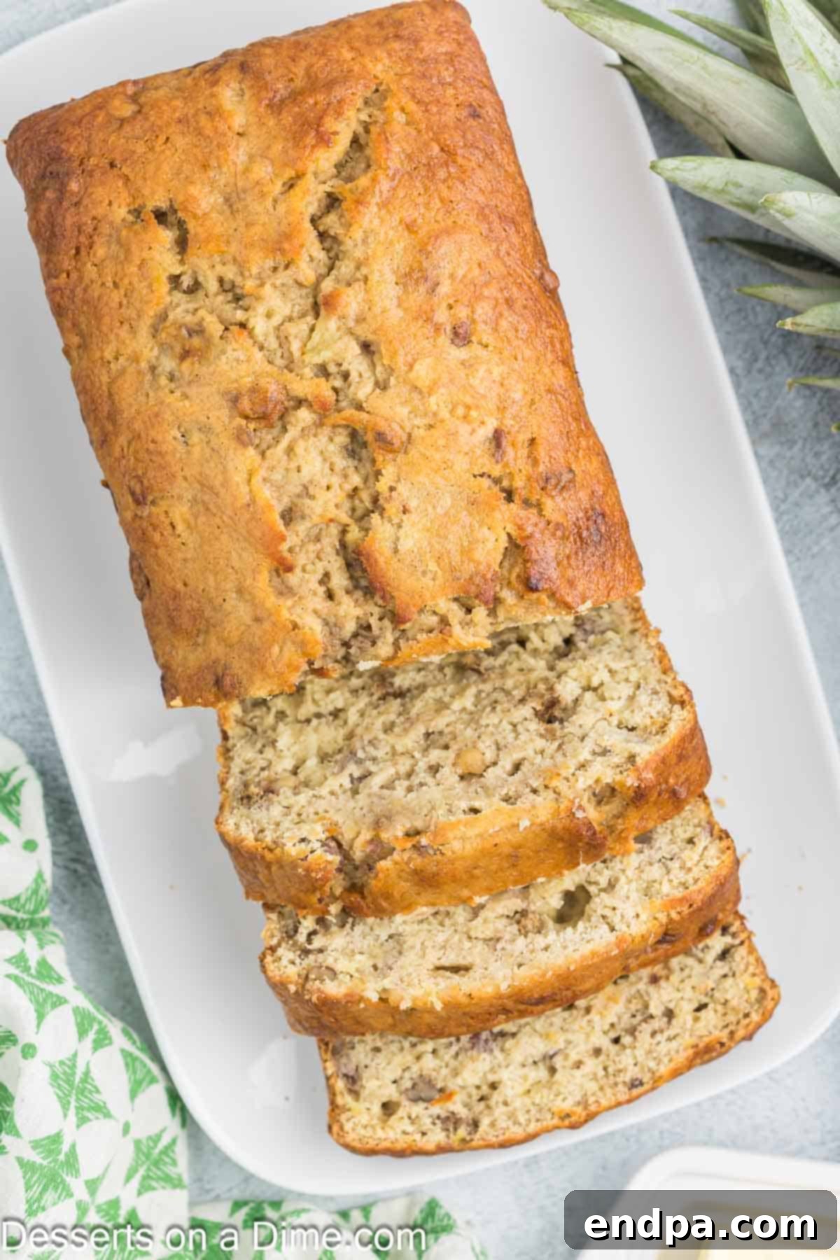 Tropical Banana Pineapple Loaf 11 Sliced Banana Pineapple Bread presented beautifully on a platter, ready to be enjoyed.