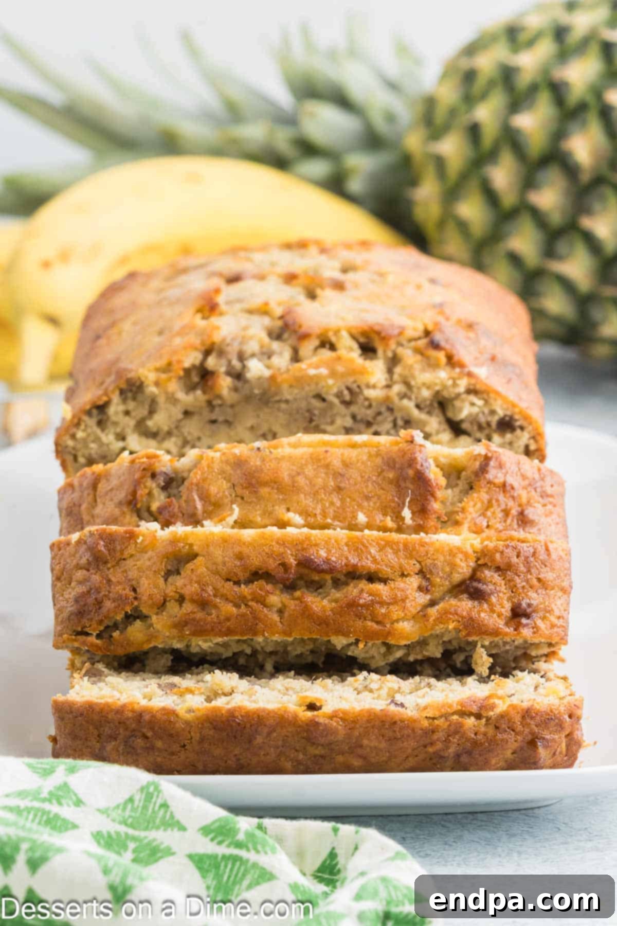 Tropical Banana Pineapple Loaf 12 Close-up of a perfectly sliced Banana Pineapple Bread, showing its tender crumb and fruit pieces.