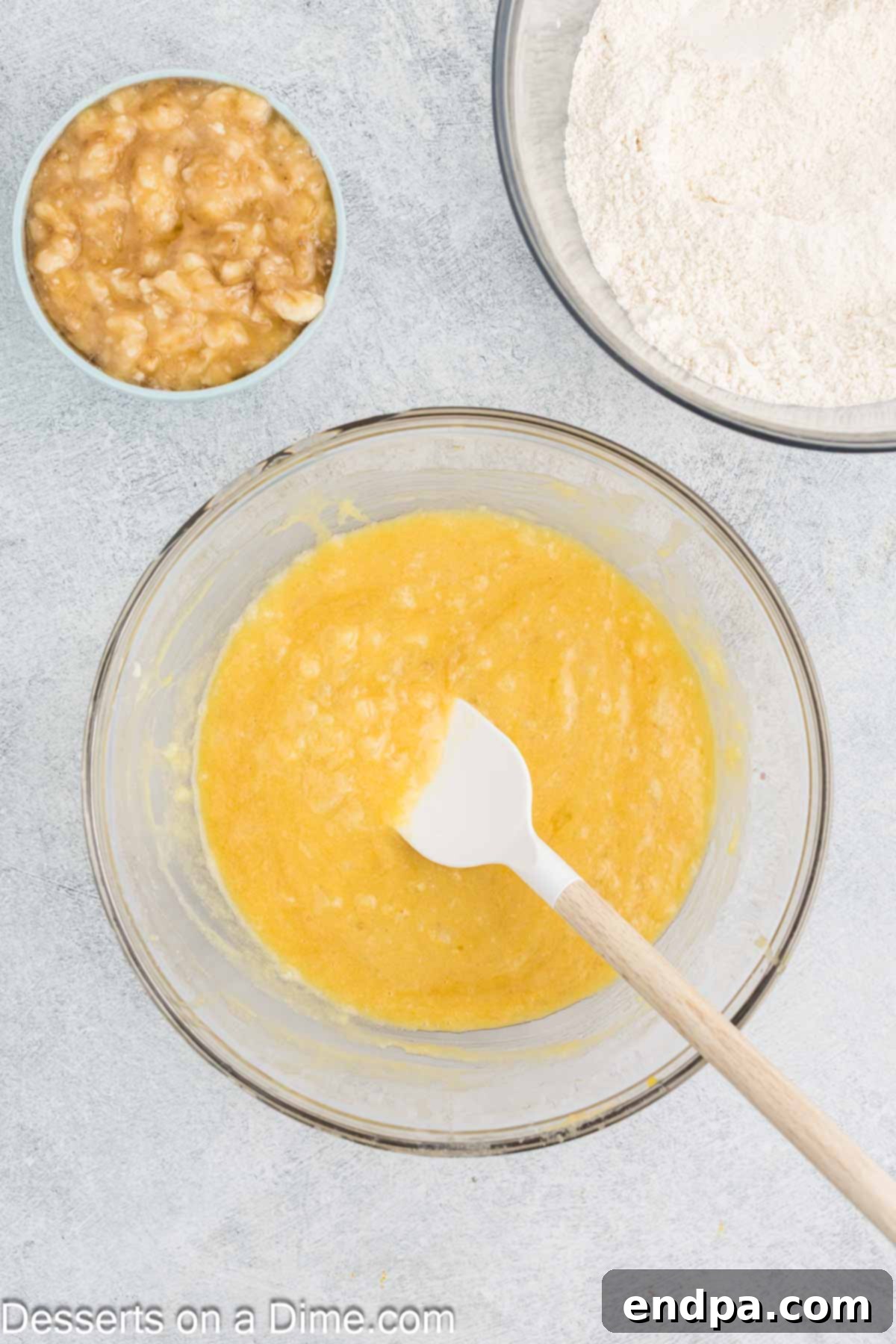 Tropical Banana Pineapple Loaf 6 Crushed pineapple, including its liquid, being folded into the wet ingredients.