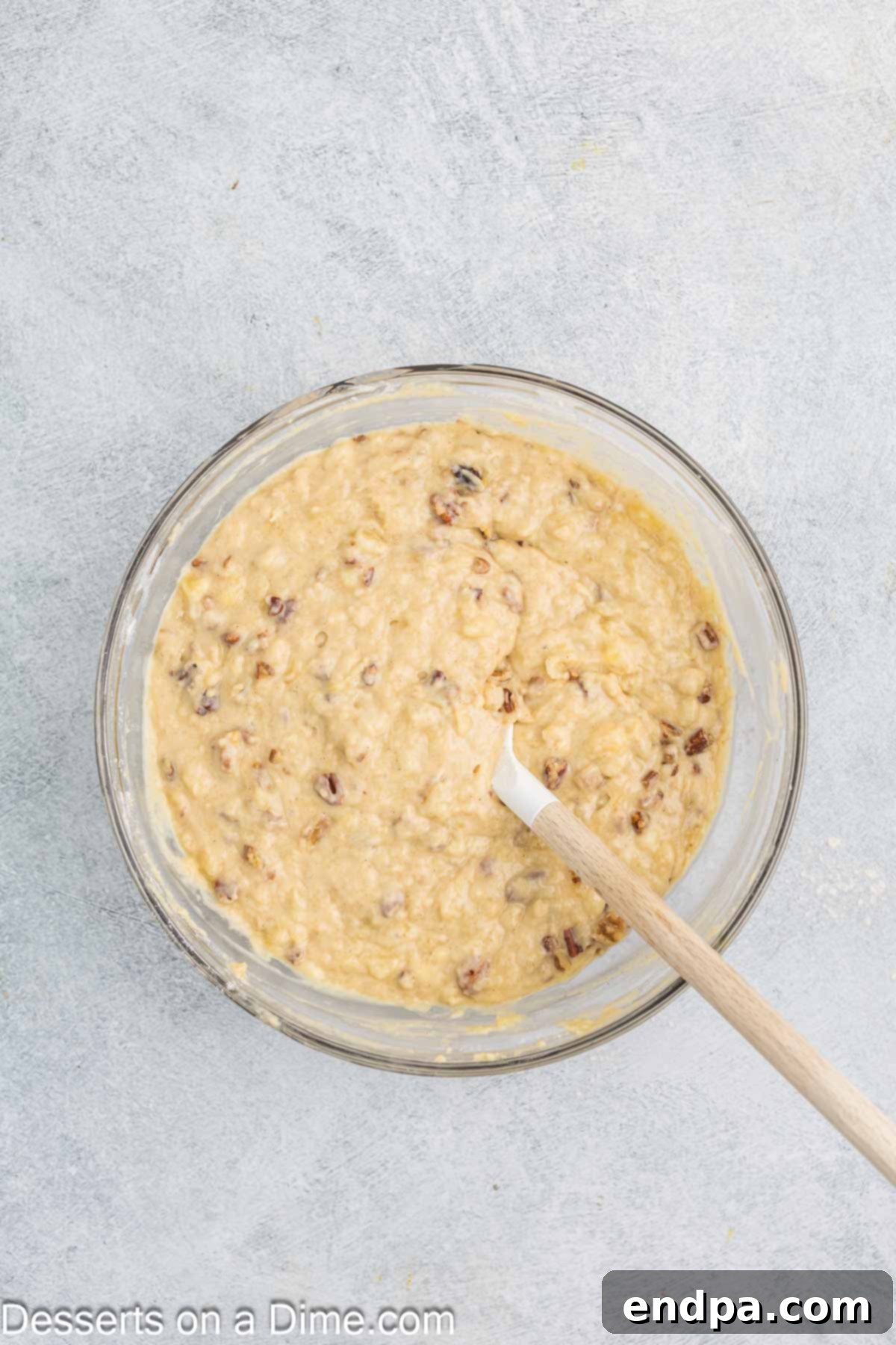 Tropical Banana Pineapple Loaf 8 Dry ingredients and nuts being folded gently into the wet mixture by hand.