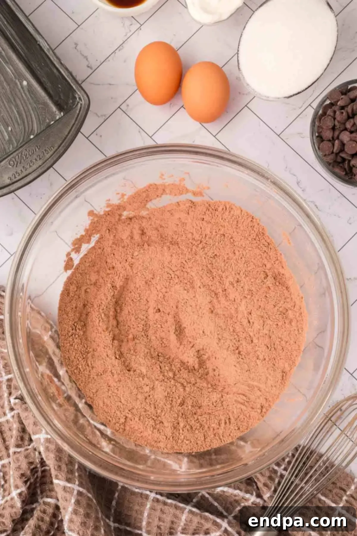Dry ingredients, including flour, cocoa powder, baking soda, baking powder, and salt, combined in a mixing bowl.
