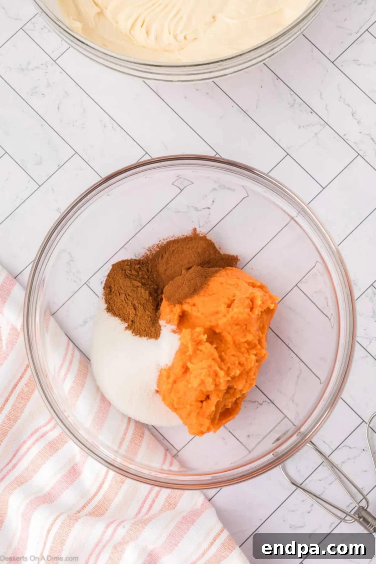 Velvet Sweet Potato Cheesecake 11 Sweet potato puree mixed with spices and sugar in a bowl.